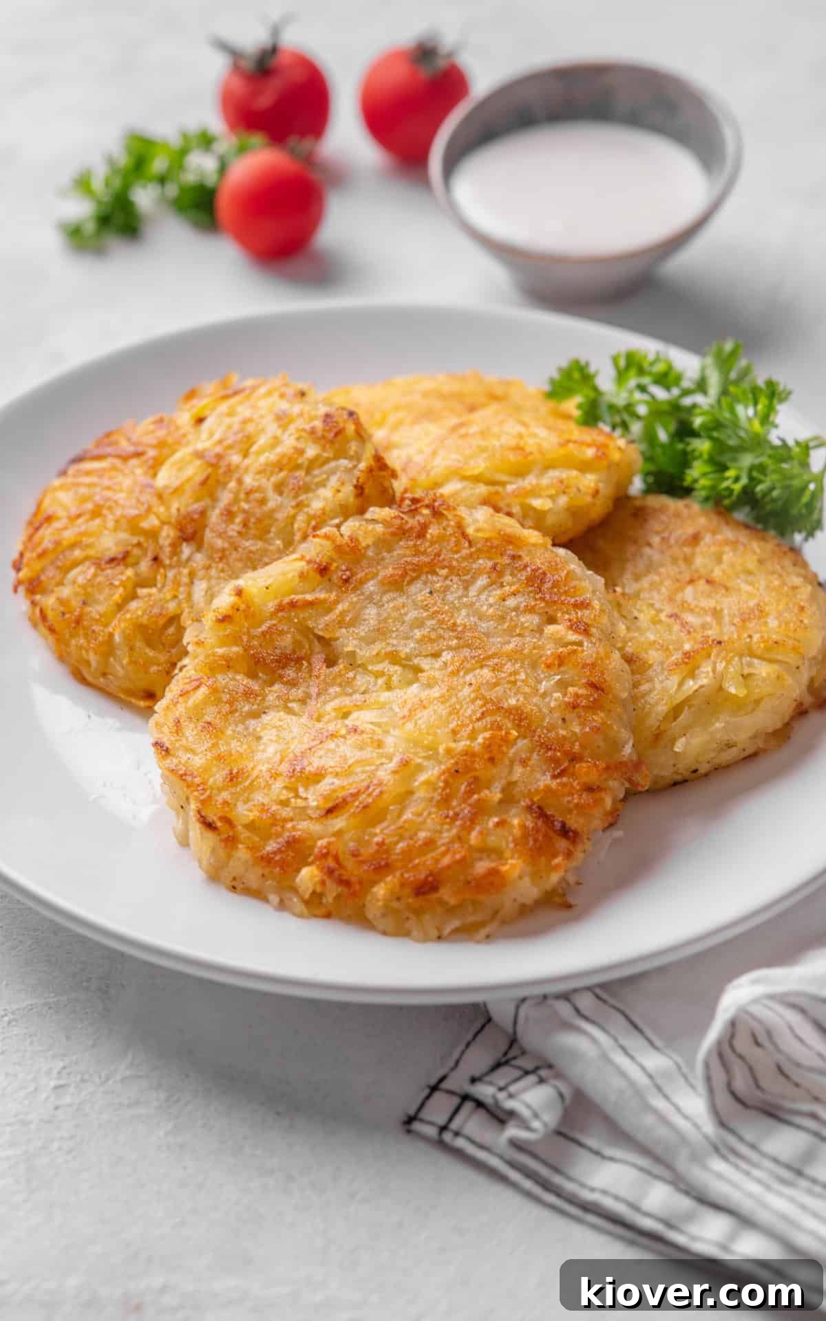 Crispy Swiss Potato Rösti Recipe — Golden Hash Brown Style 9 potato pancakes served on a plate.