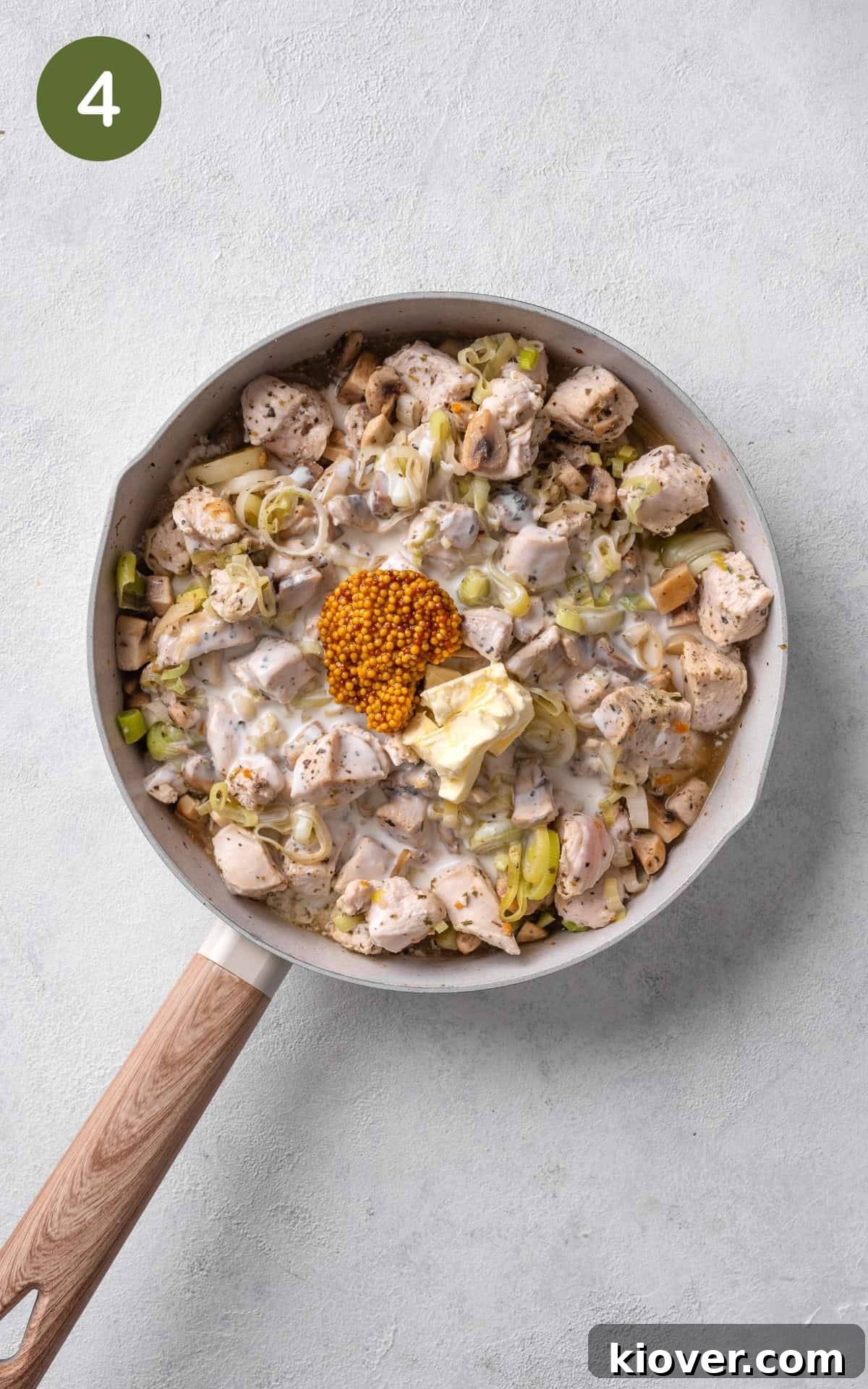 Classic Chicken and Leek Pie Recipe for Comforting Dinner 7 adding whole-grain mustard and cooking cream to the pan.