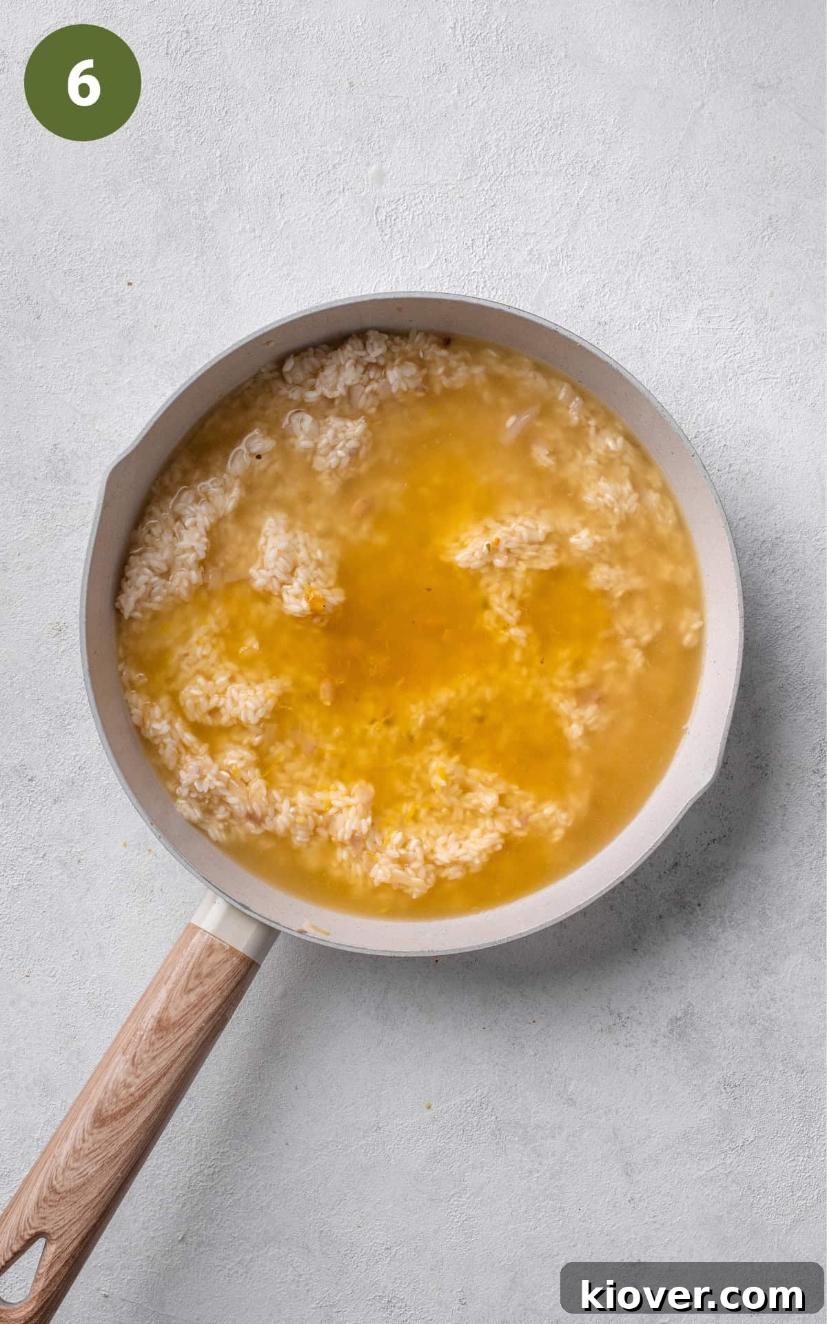 rice and chicken stock, with lemon juice in a pan.