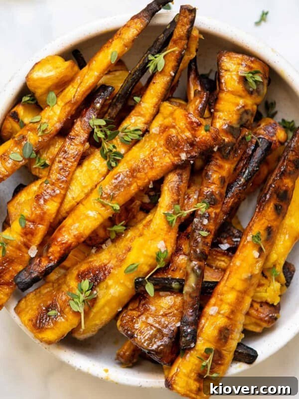 Creamy Carrot and Parsnip Soup Recipe for Cozy Weeknights 11 mustard maple glazed parsnips in white bowl on backdrop