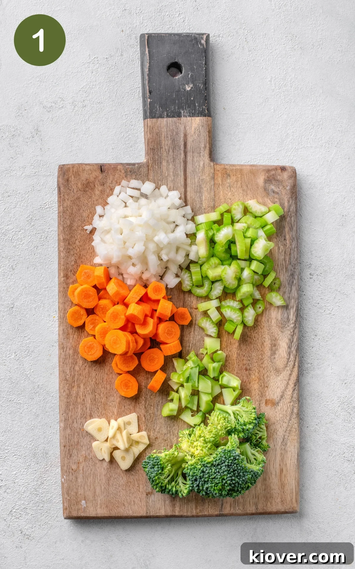 Creamy Broccoli Soup Recipe with Garlic and Cheddar 4 colourful vegetables on a wooden cutting board.