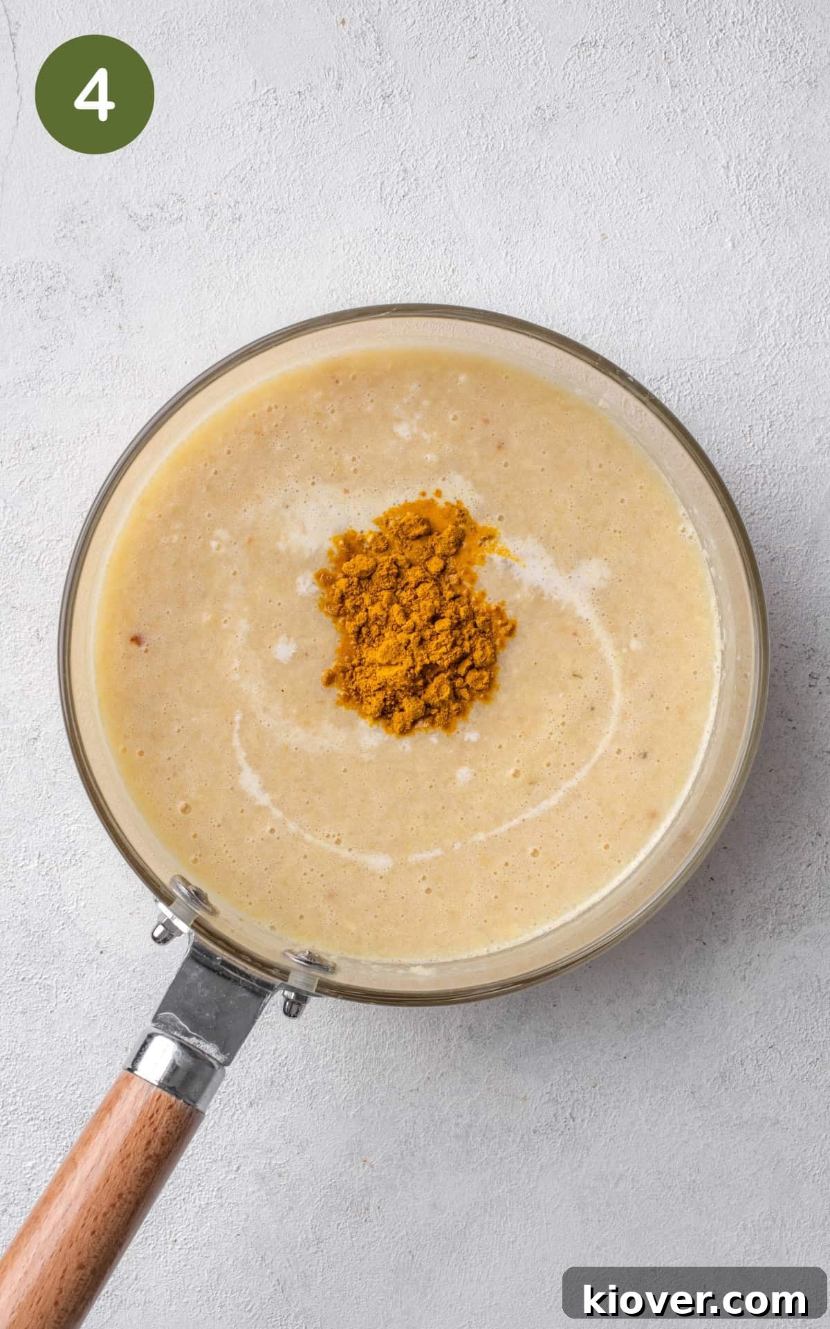 parsnip soup in a saucepot with curry powder and soya cream.