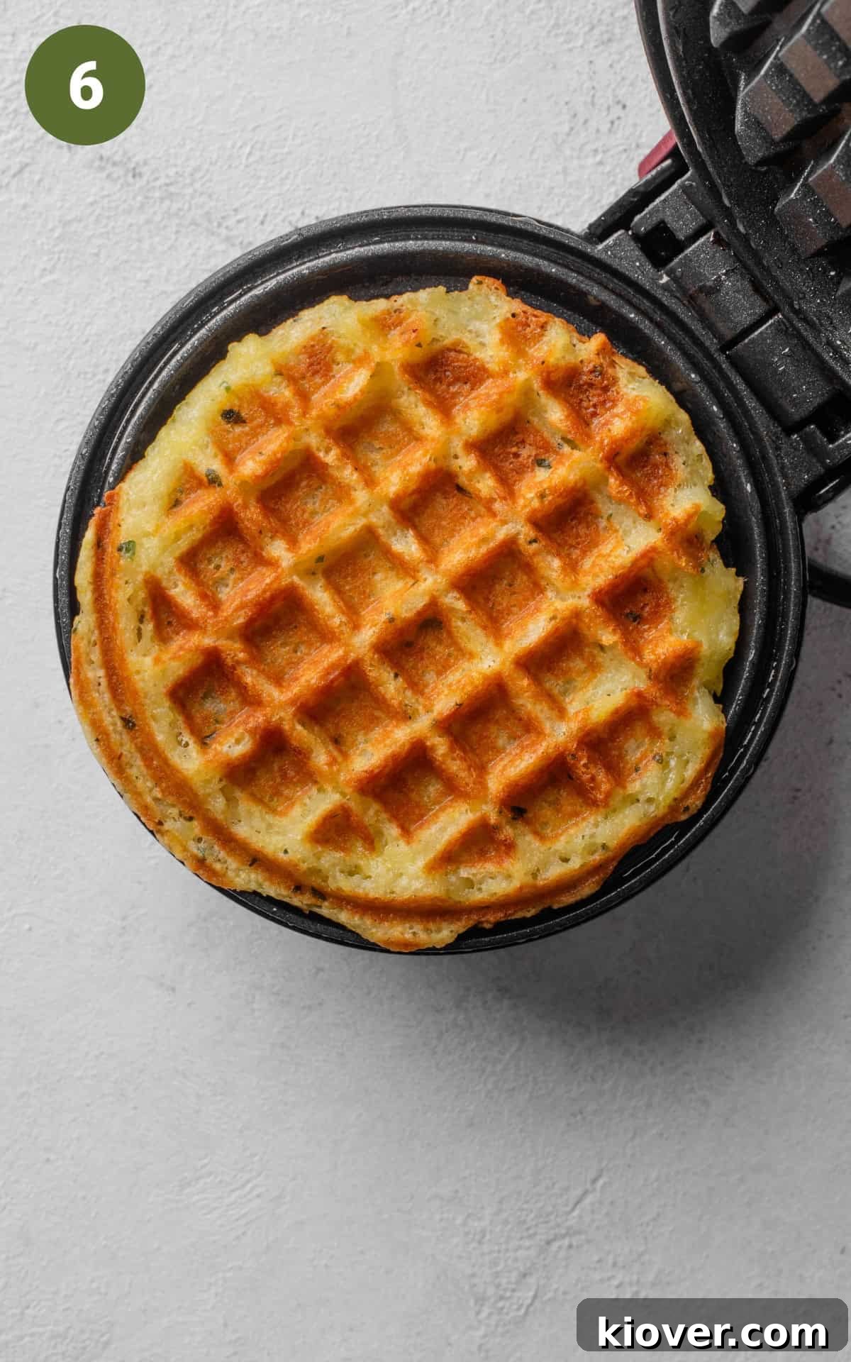 Crispy Potato Waffles Recipe: Homemade Hash Brown Waffles 9 golden brown waffle on a waffle iron.