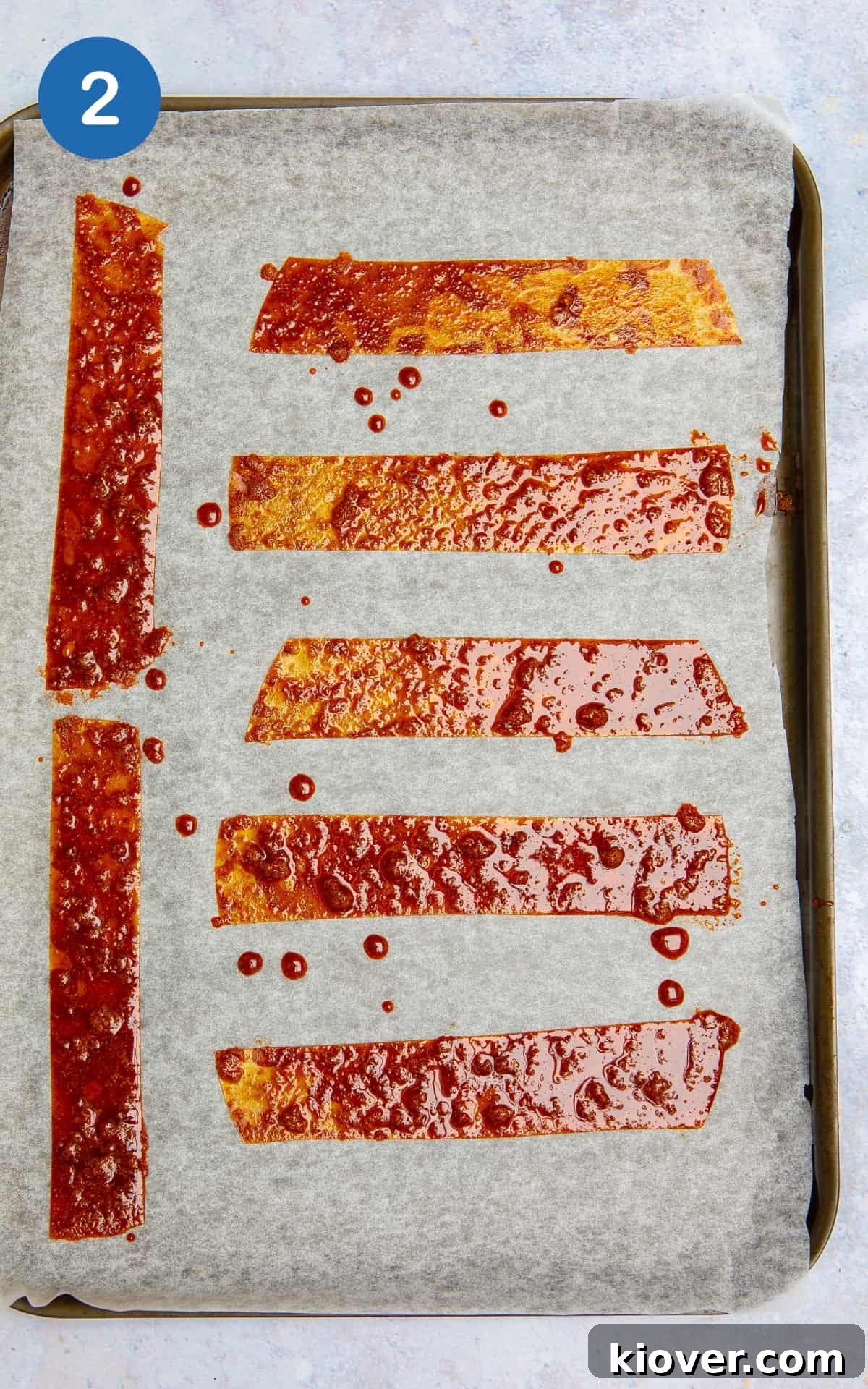 rice paper strips with sauce on a baking tray.