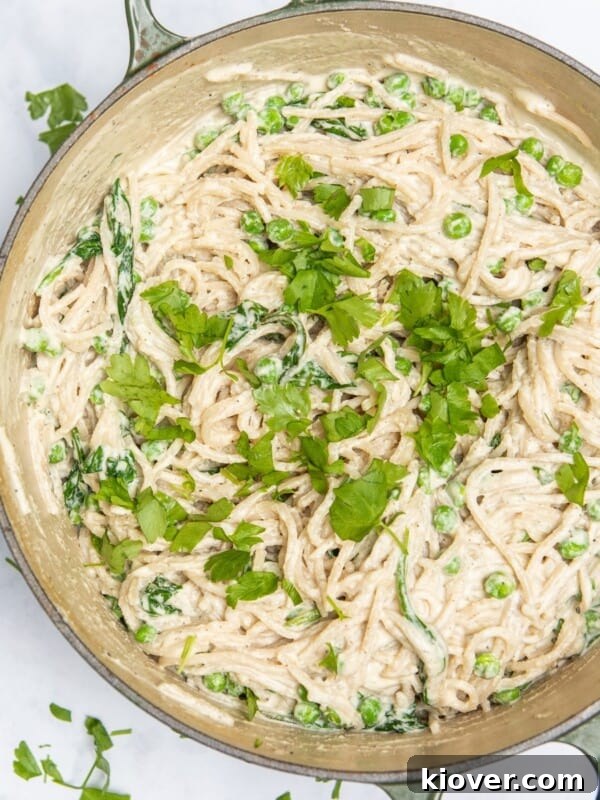 spaghetti carbonara in large frying pan topped with freshly chopped parsley