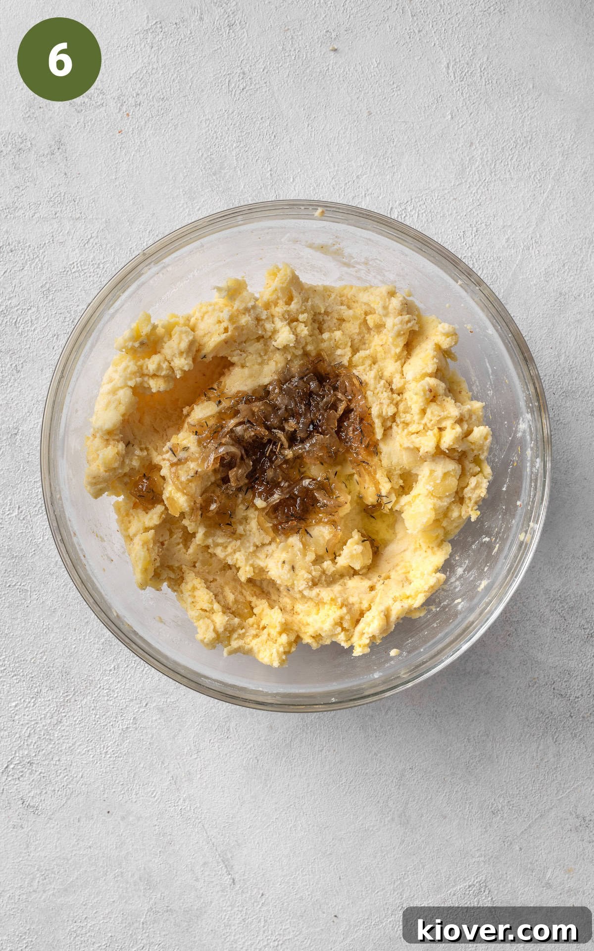 adding grated cheddar cheese to the mixture.