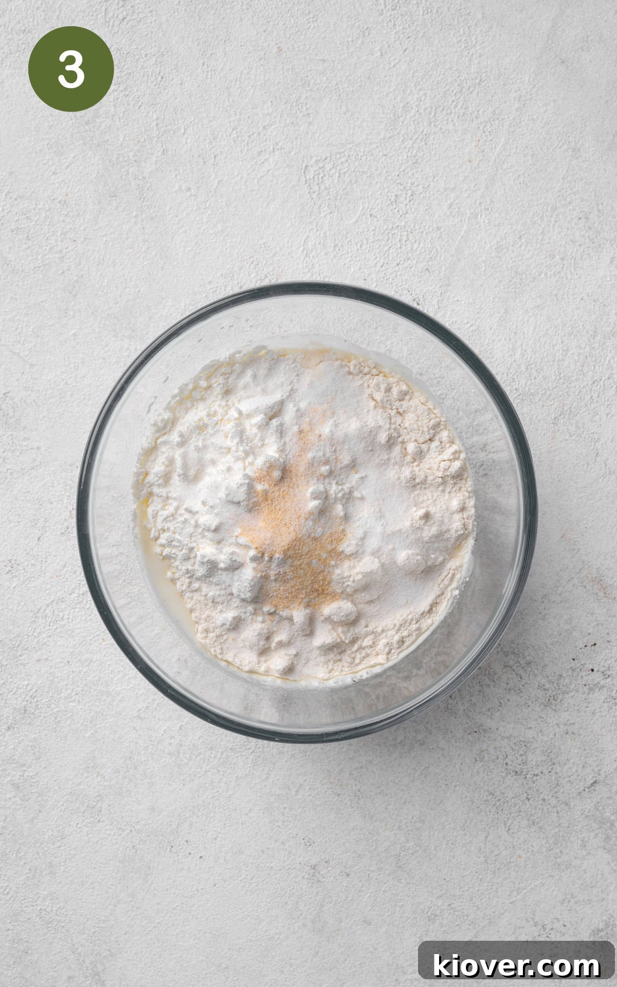 flour, cornstarch, almond milk, lemon juice, garlic powder, salt, and pepper combined in a bowl.