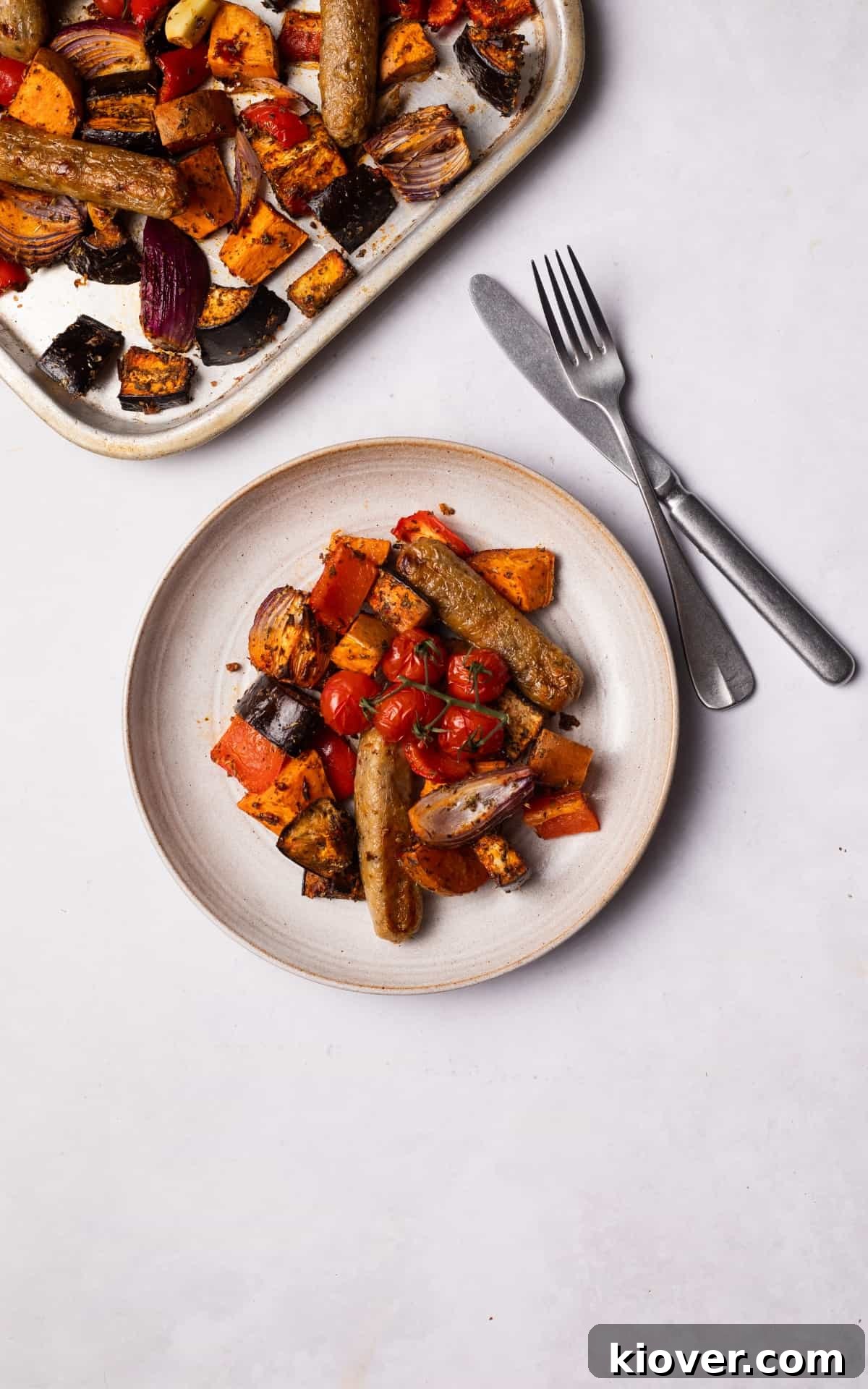 Sausage Tray Bake Recipe with Roasted Veggies and Herb Gravy 7 Sausage Tray bake served on a plate.