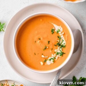 sweet potato soup garnished with parsley and cashews.