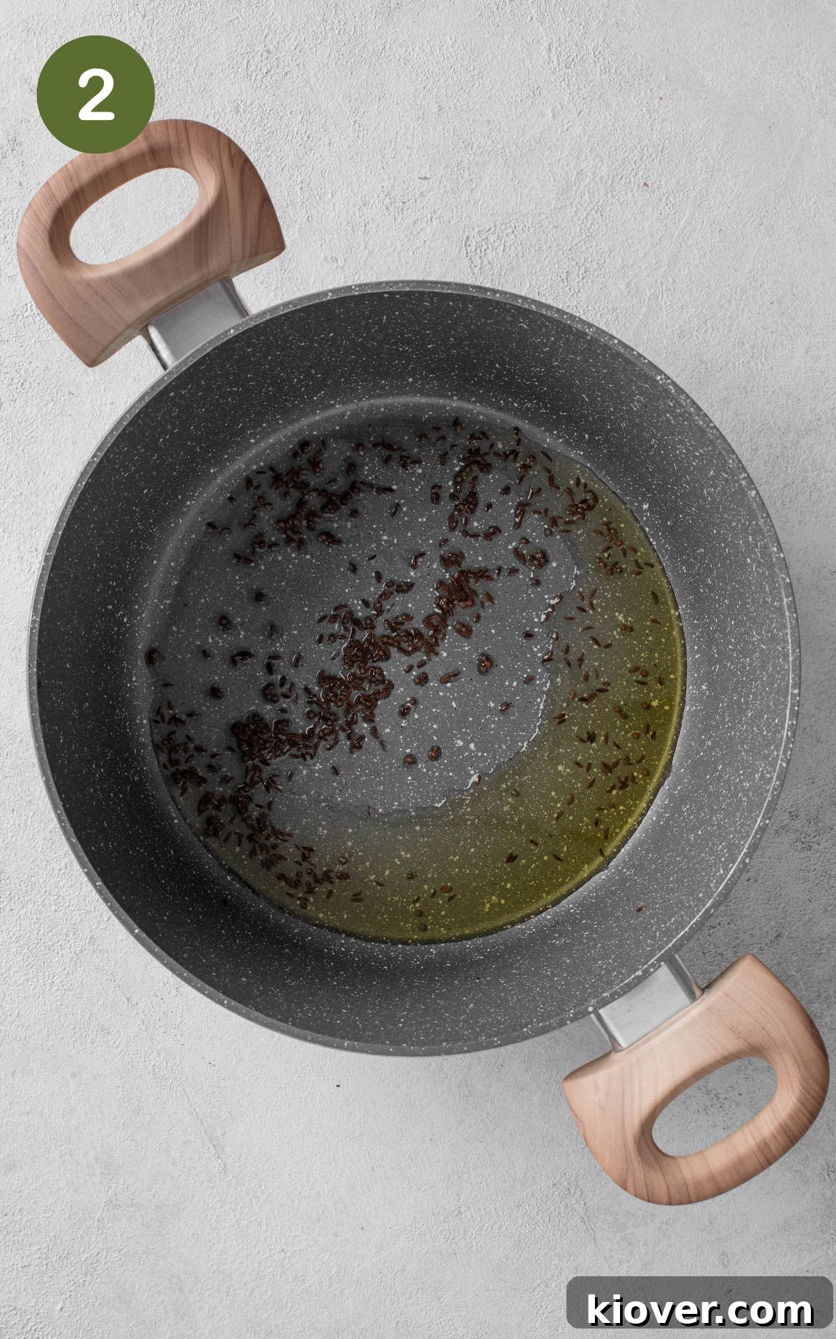frying spices in a pot with oil.