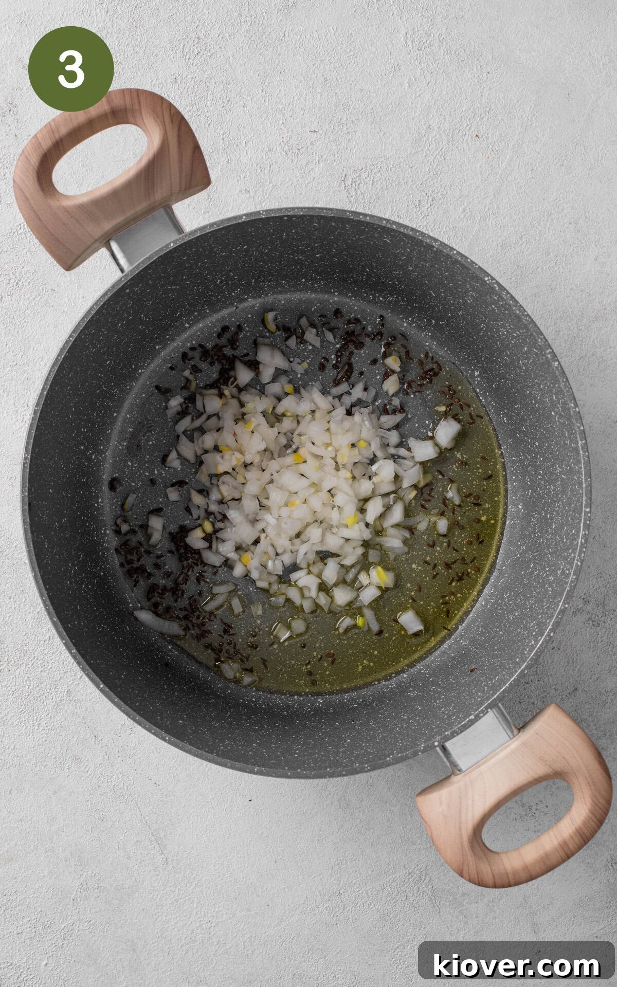 frying onion and spices in a pot with oil.