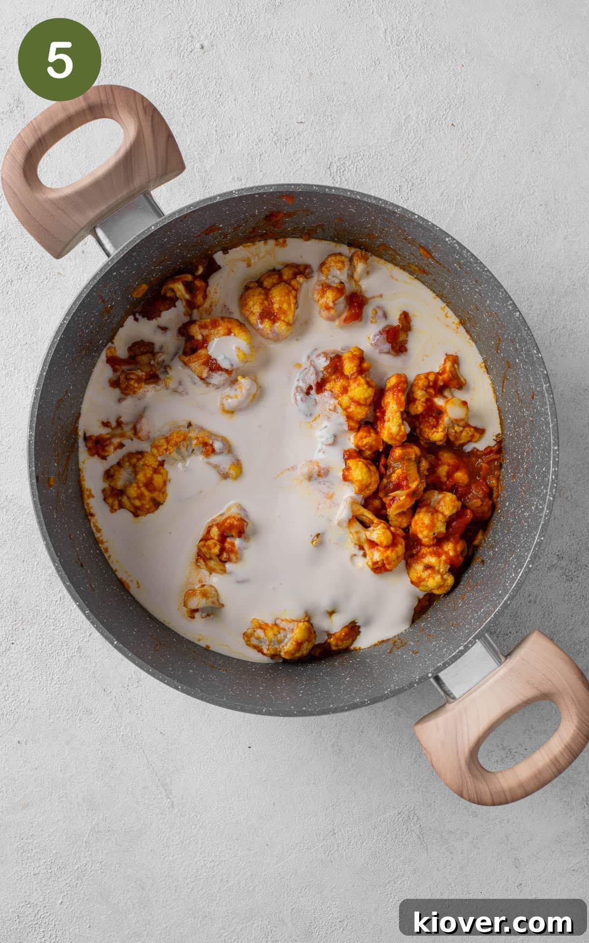 adding cauliflower and coconut milk for the cauliflower curry.