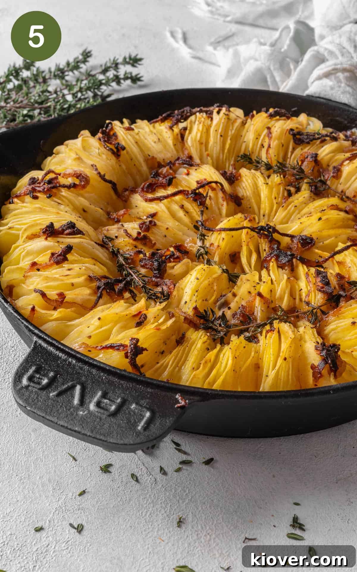 Classic Boulangère Potatoes Recipe: Crispy Potato and Onion Bake 8 potatoes in a skillet with onions and thyme.
