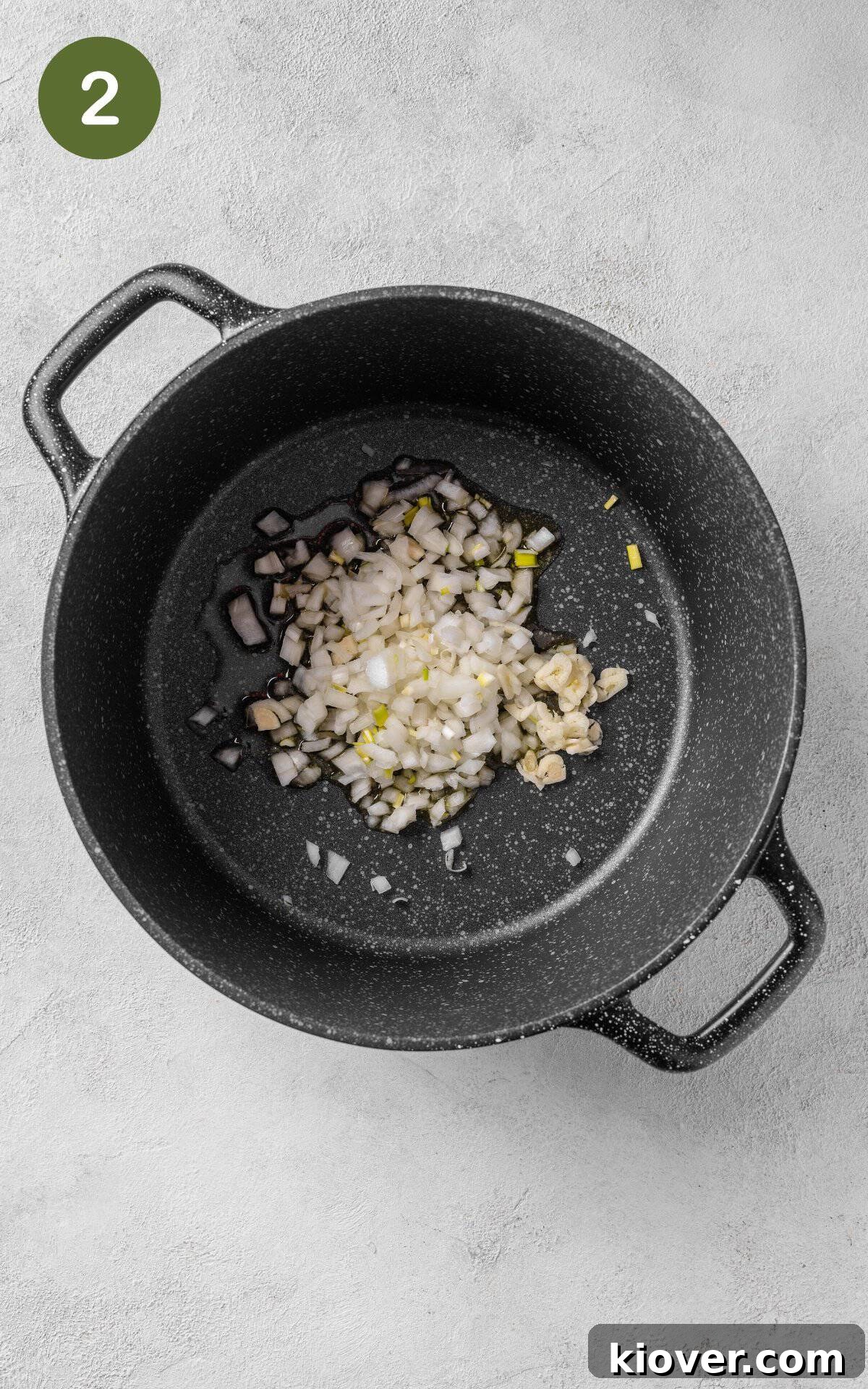 Chopped onions and garlic in a saucepan.
