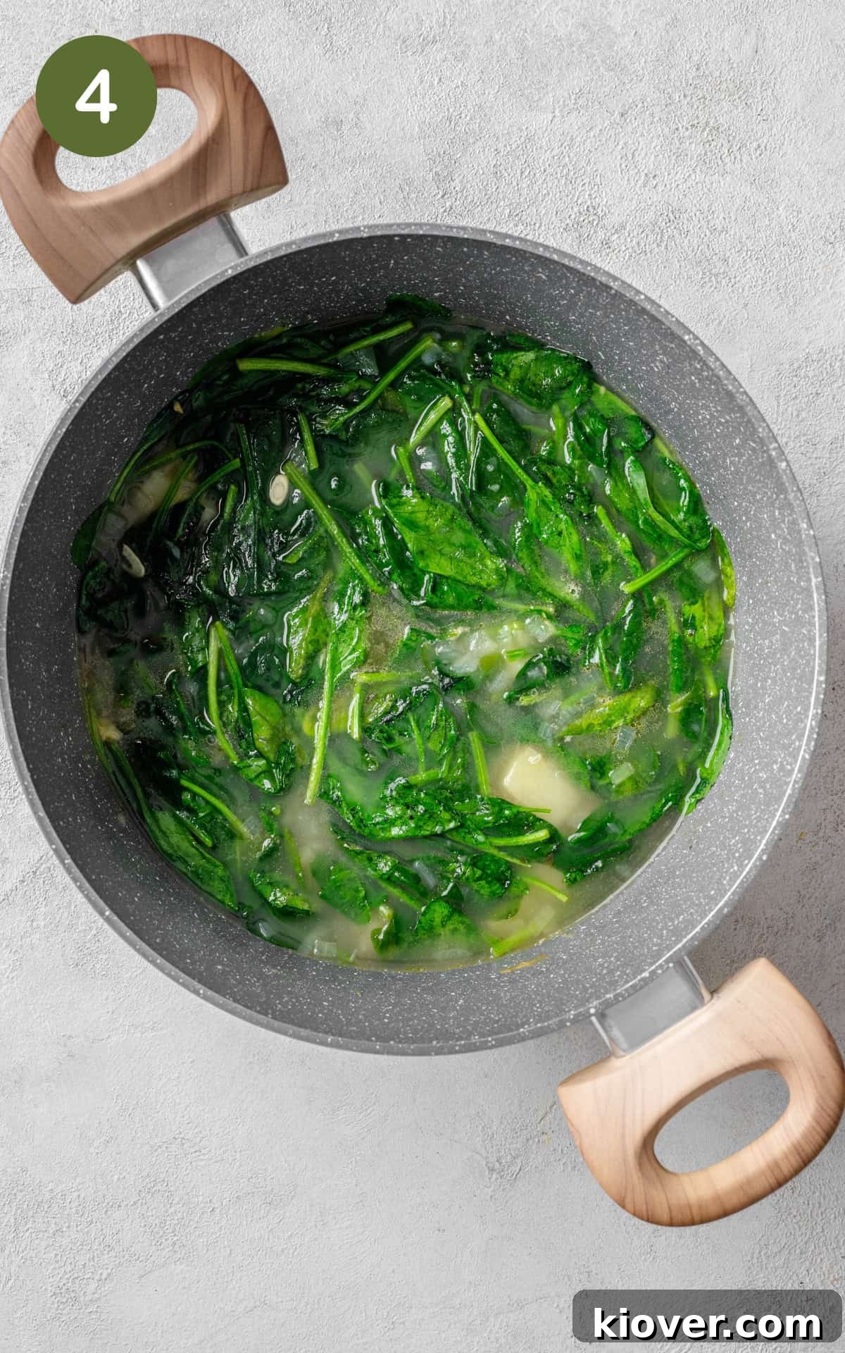 Creamy Spinach Soup Recipe with Garlic and Lemon 7 Spinach cooking in a pot.