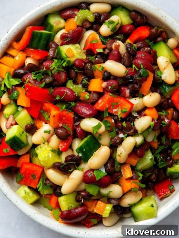 mixed bean salad in large bowl on white surface