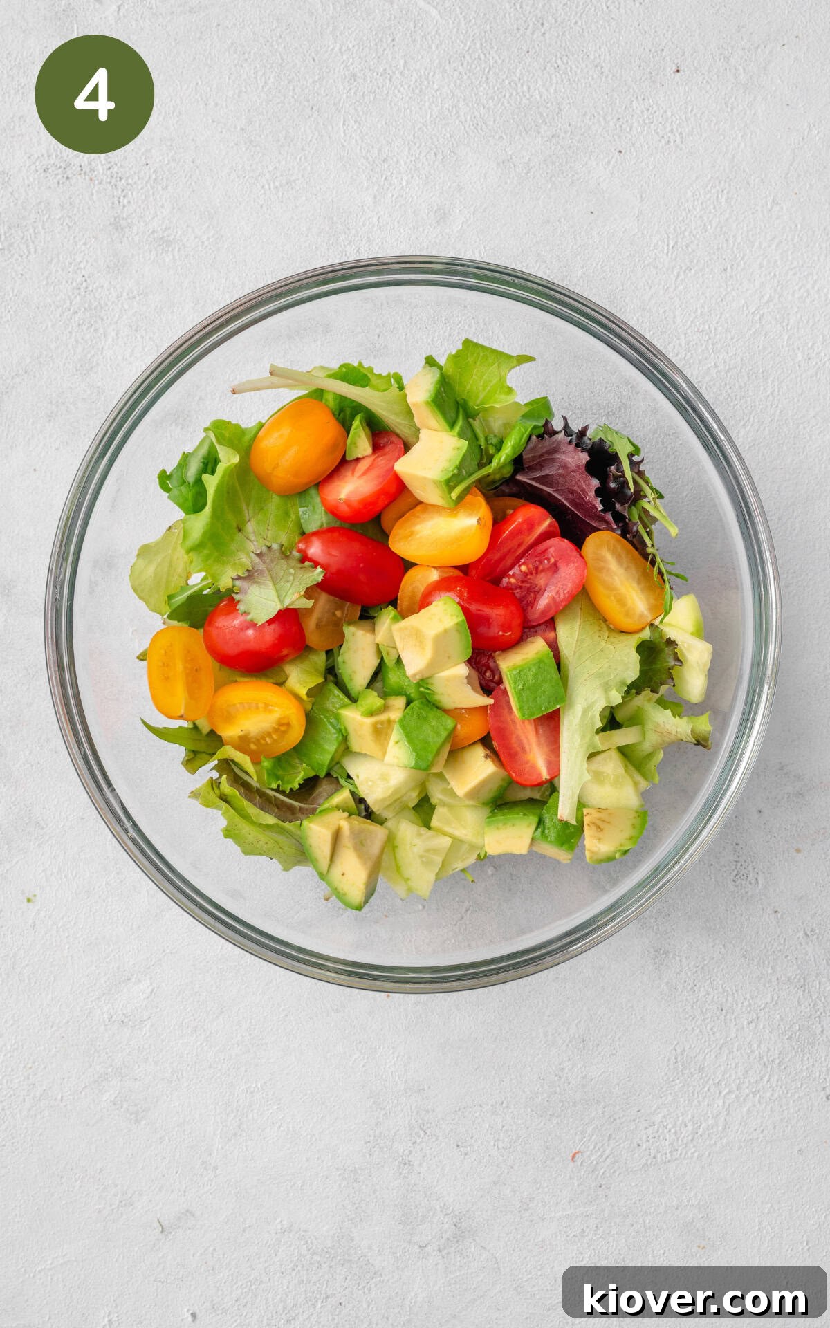 Smoked Salmon Salad with Avocado & Lemon-Dill Dressing 7 Mixed greens salad and chopped vegetables in a mixing bowl.