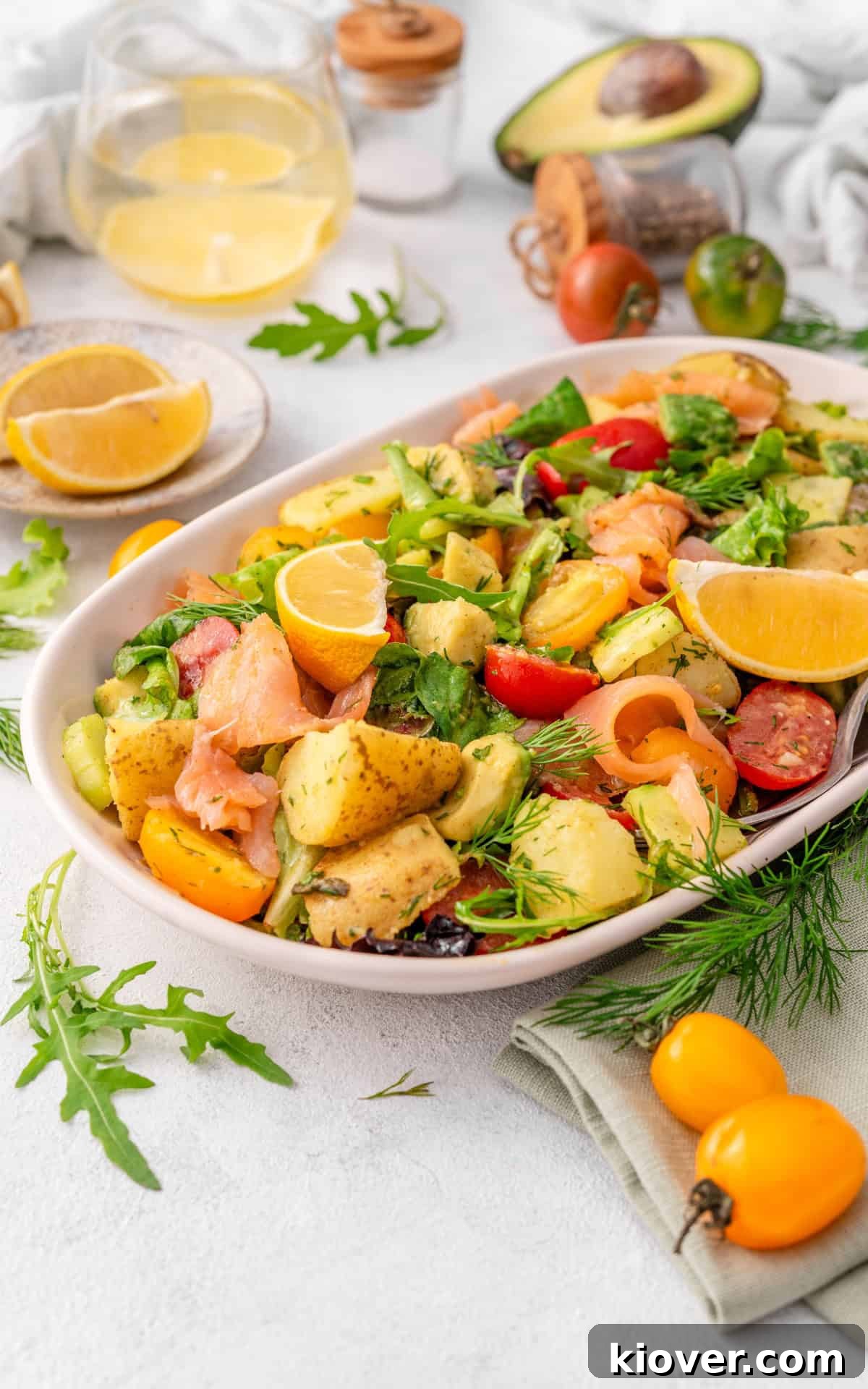 Smoked Salmon Salad with Avocado & Lemon-Dill Dressing 10 Smoked Salmon salad served on a plate with lemon slices and herbs on top.