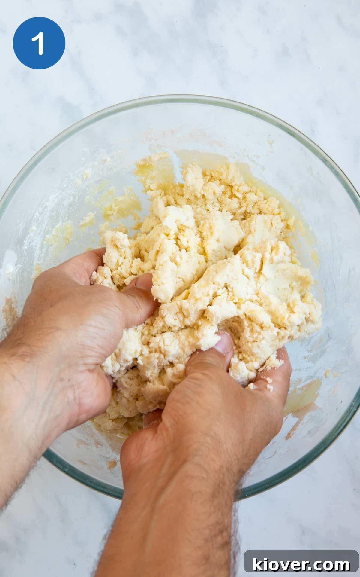 focaccia dough being mixed in transparent mixing bowl on white background 