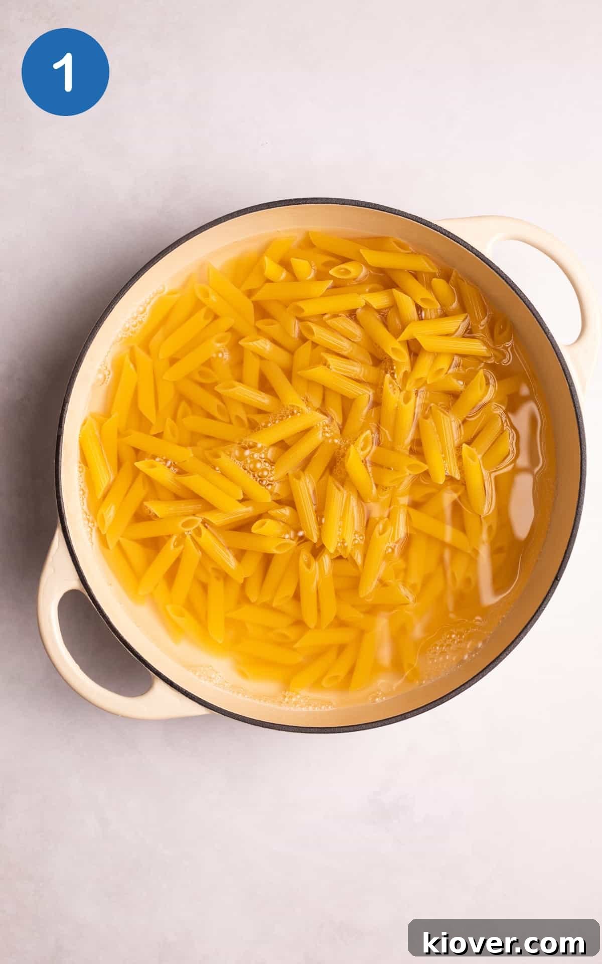 Pasta boiling in water in a large casserole pot.