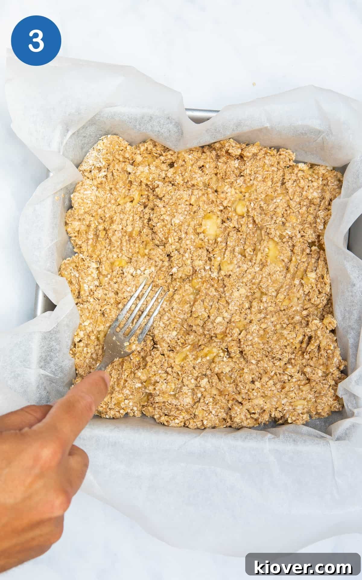 Banana Breakfast Bars with Oats and Nuts receita 6 banana oat bars pressed into a square tin ready for baking.