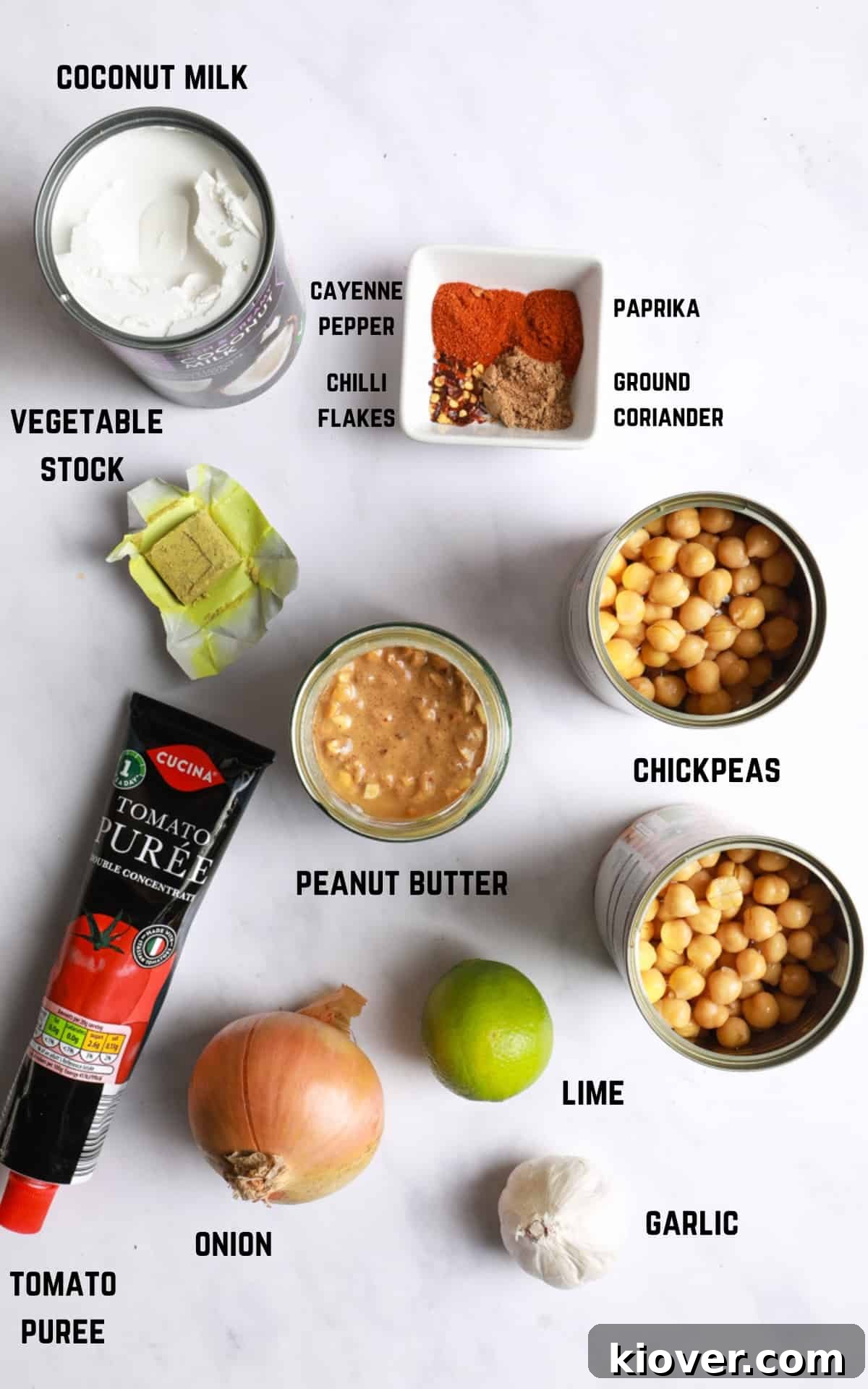 ingredients to make peanut butter curry laid on white marble background.