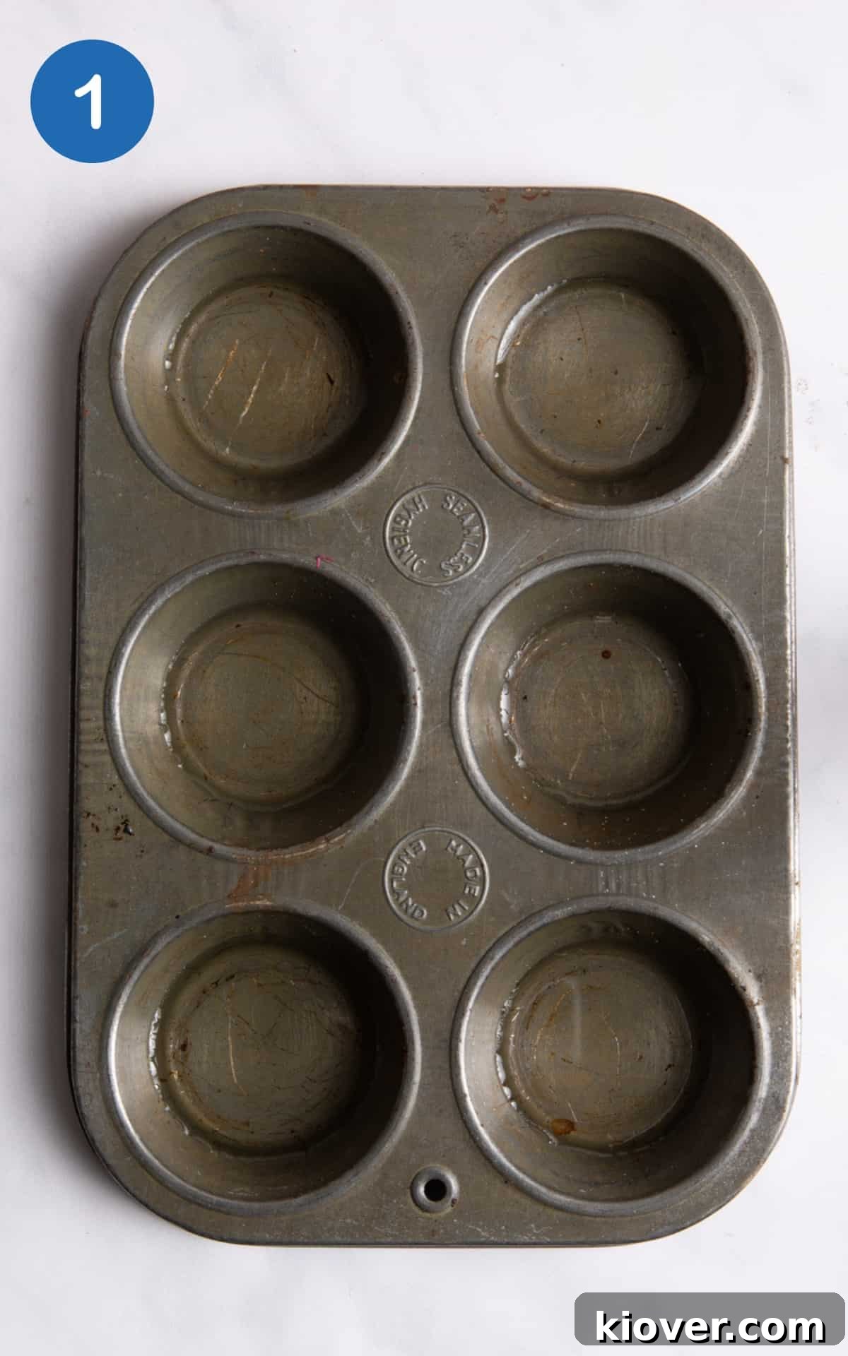 Gluten-Free Vegan Yorkshire Puddings Recipe 4 Muffin tray tray with sunflower oil each hole laid on white background.