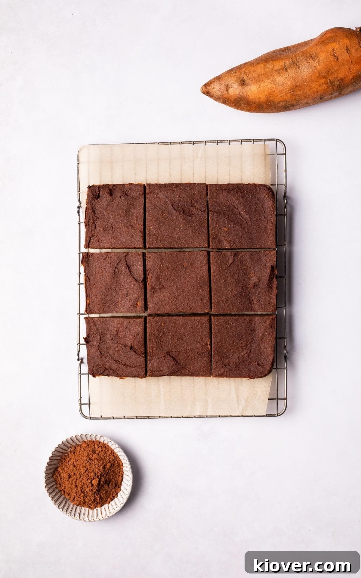 Fudgy Sweet Potato Brownies Recipe with Cocoa and Maple 10 Sliced Sweet Potato Brownies on a baking paper.