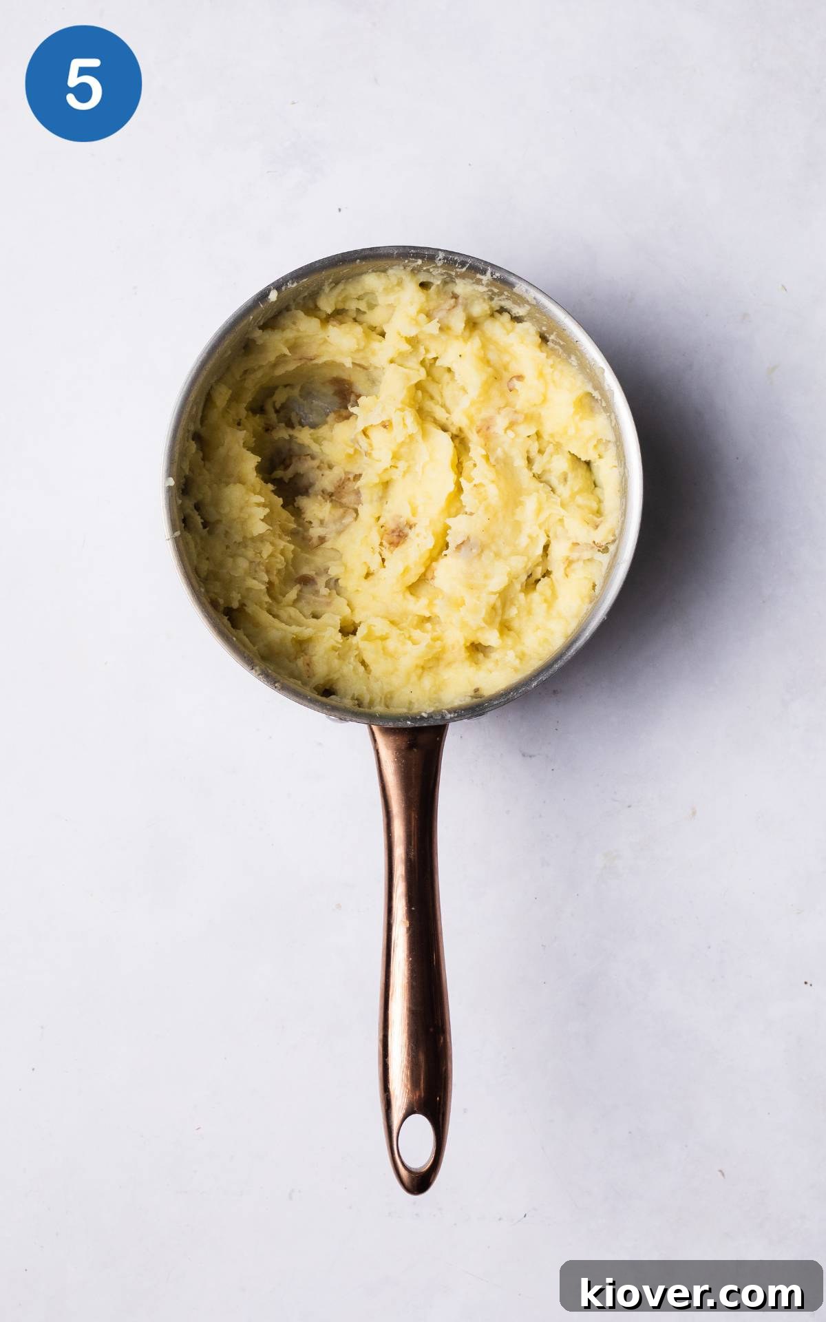 Hearty Lentil Cottage Pie Recipe for Comforting Weeknight Dinners 7 mashed potatoes in a pot.