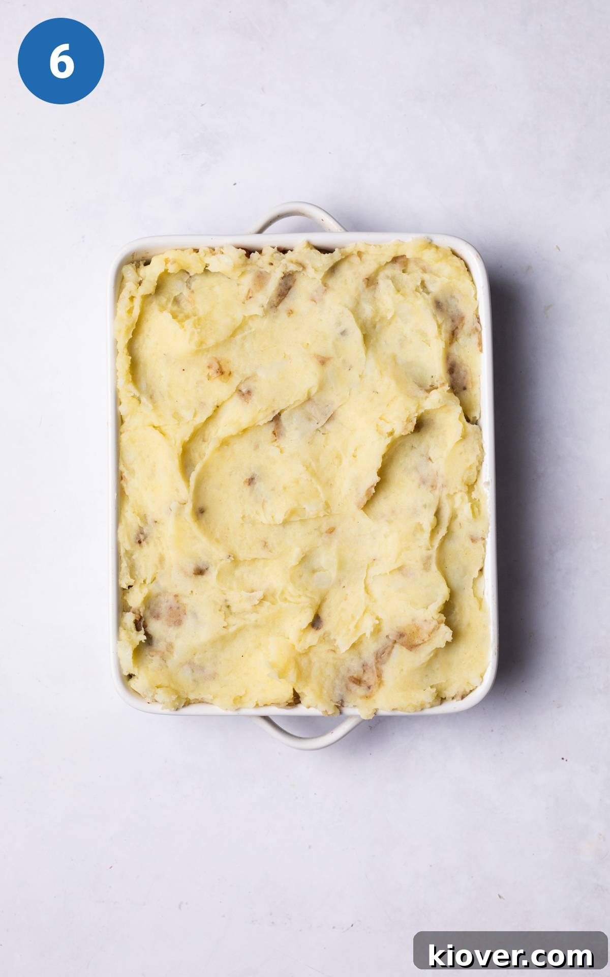Hearty Lentil Cottage Pie Recipe for Comforting Weeknight Dinners 8 lentil pie mixture topped with mashed potatoes.