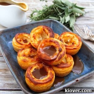 gluten free and vegan yorkshire puddings served in a blue dish with gravy.