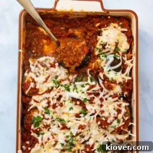 Creamy Baked Eggplant Casserole with Garlic and Herbs 13 Aubergine bake being served with a silver spoon