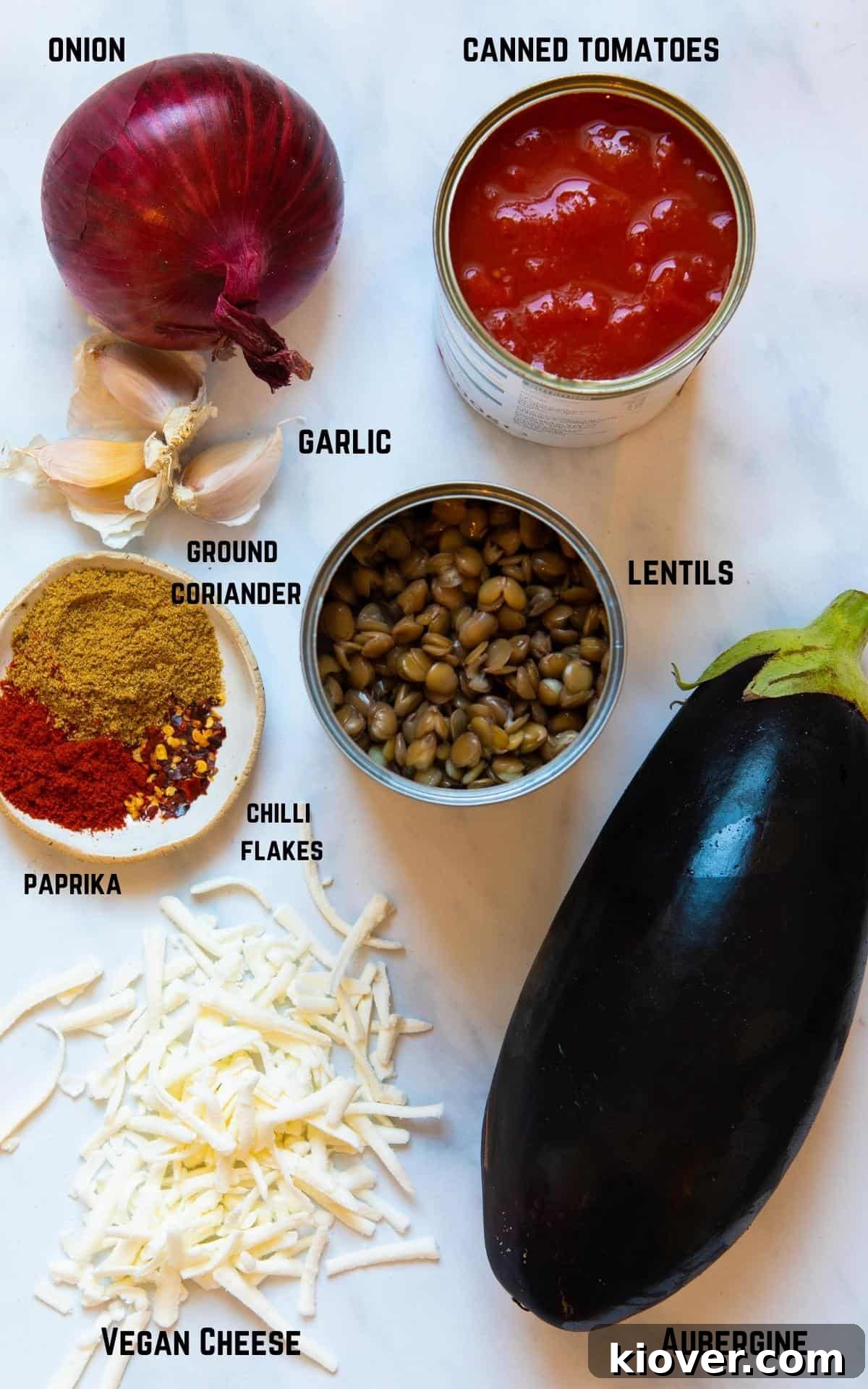 Creamy Baked Eggplant Casserole with Garlic and Herbs 3 Ingredients to make aubergine bake displayed on white marble background.