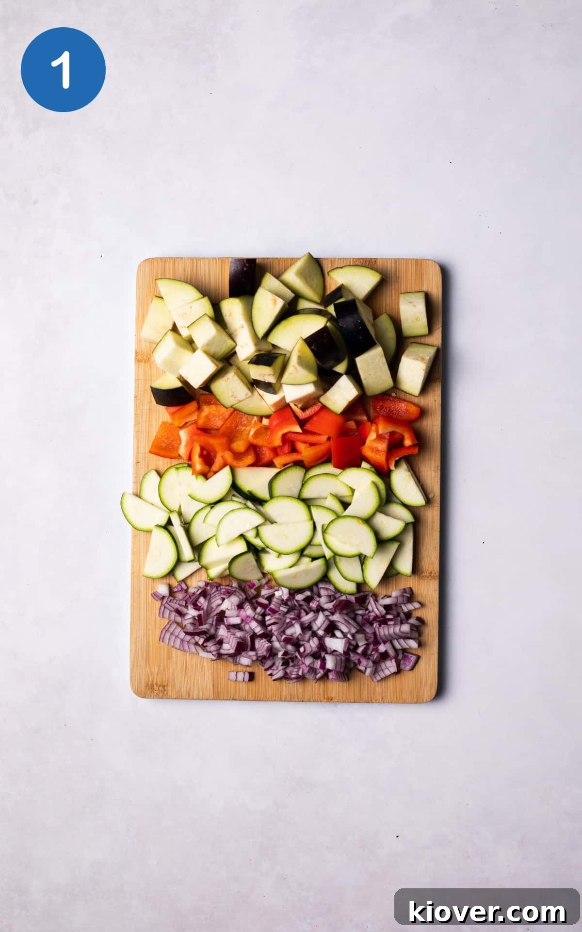 Hearty Vegetable Curry Recipe with Coconut and Spices 4 Diced onion and chopped vegetables on a cutting board.