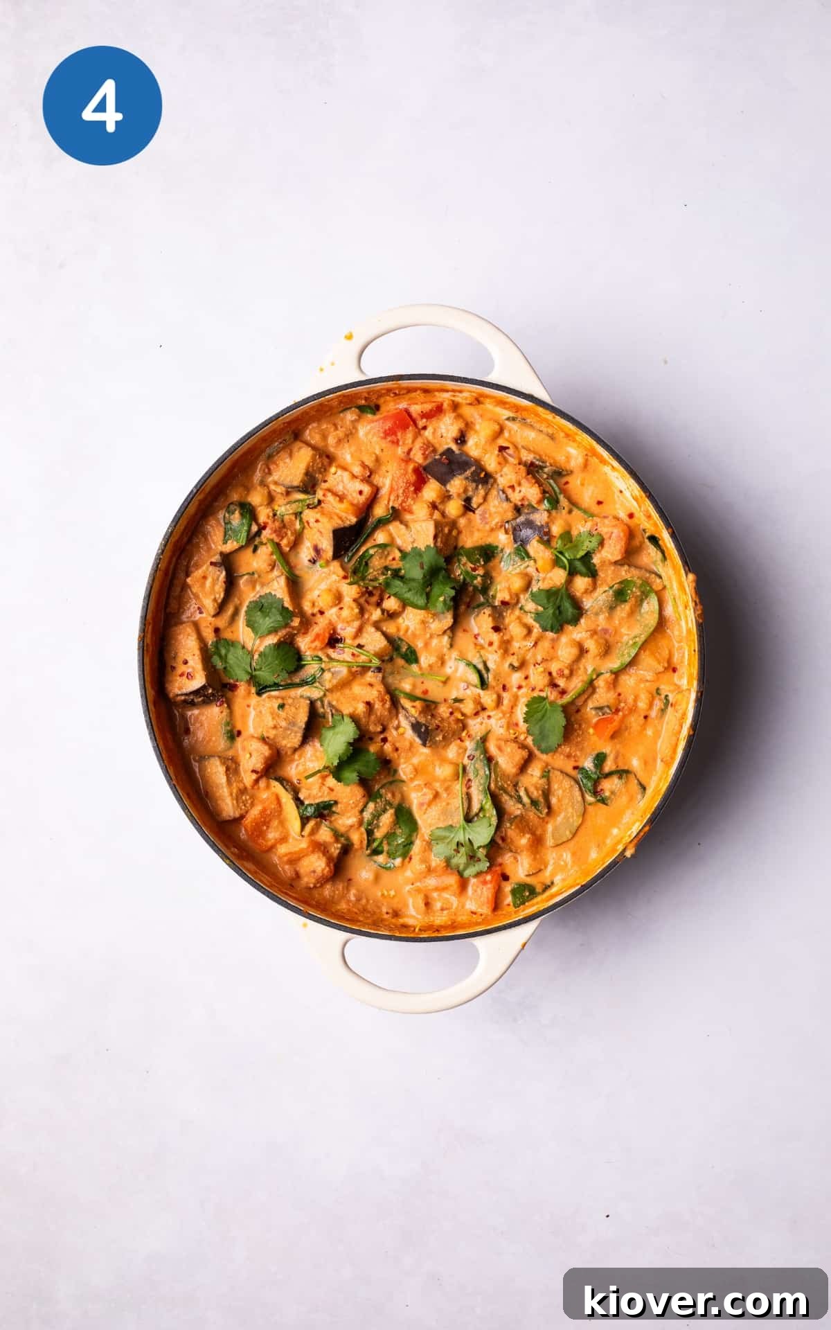 Hearty Vegetable Curry Recipe with Coconut and Spices 7 Fresh coriander and spinach on top of Vegetable Curry.