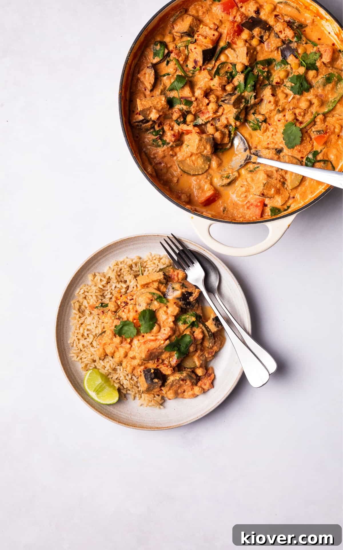 Hearty Vegetable Curry Recipe with Coconut and Spices 8 Vegetable Curry served with lime, brown rice and fresh coriander on top.