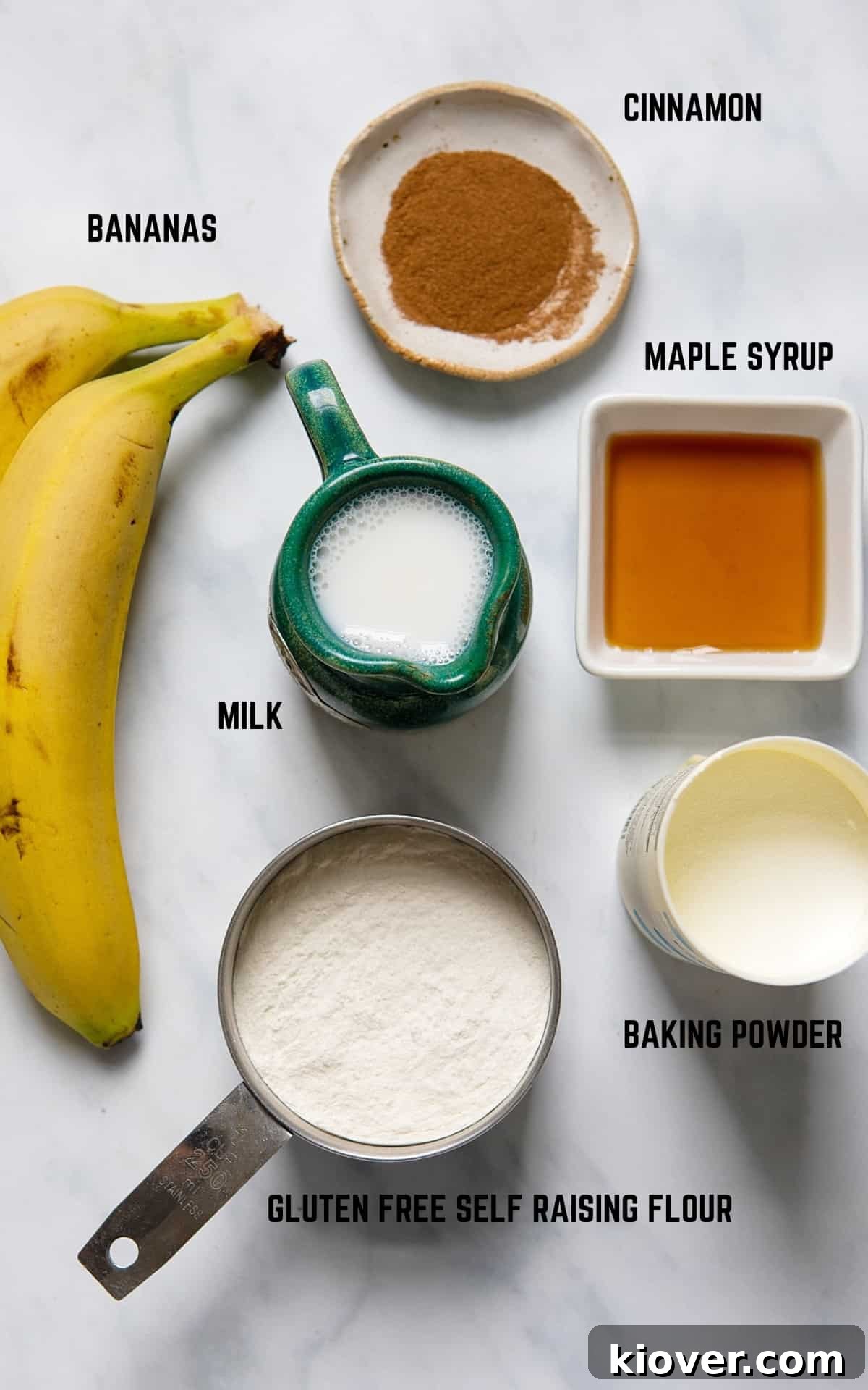 Banana Pancakes ingredients on a white marble background.