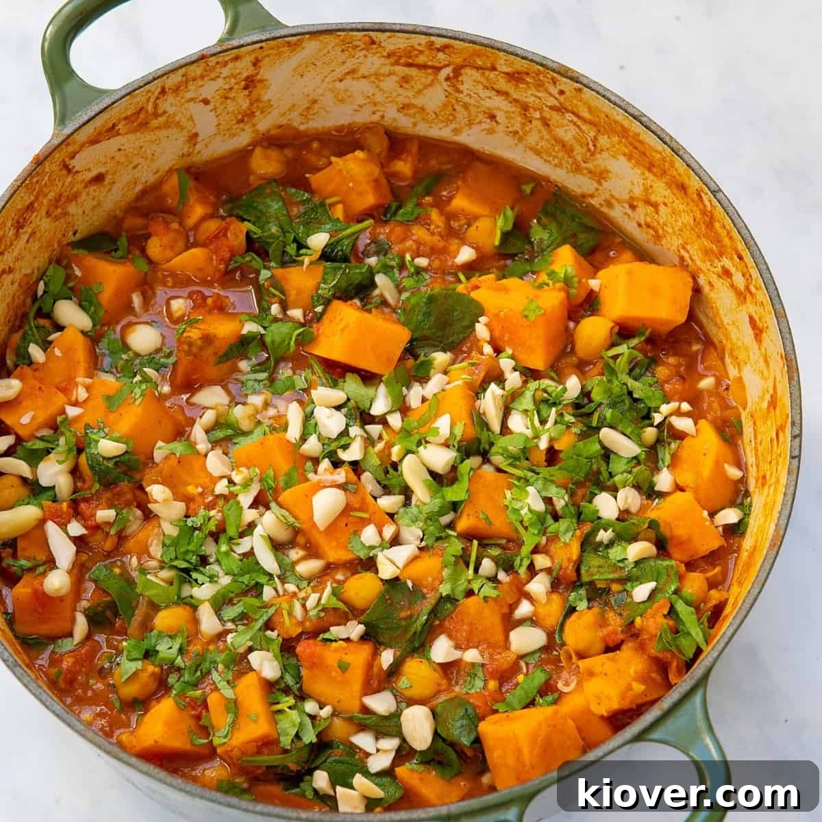 Creamy African Peanut Stew with Sweet Potatoes and Spinach 2 Peanut stew with sweet potatoes in a pot.