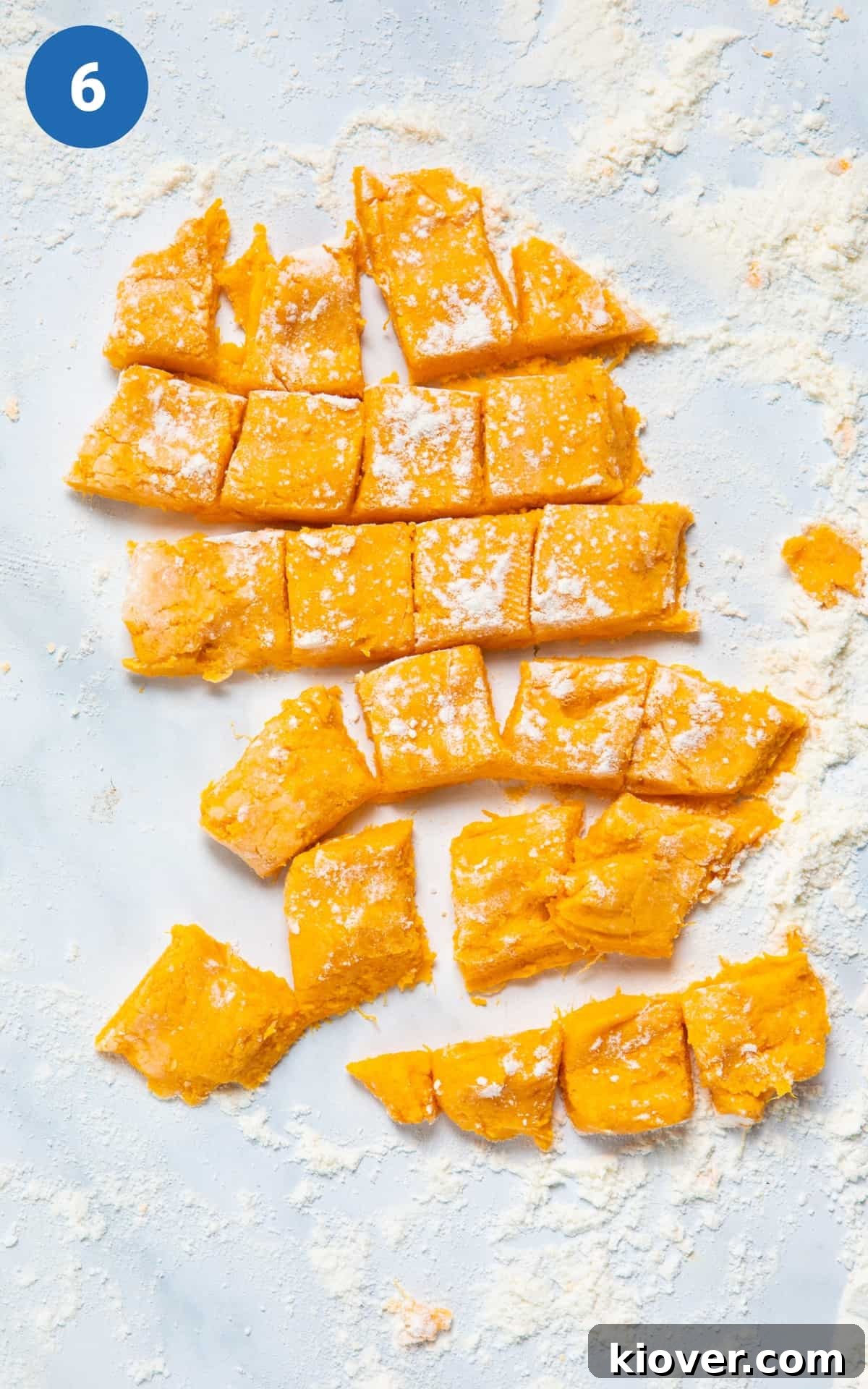 Sweet Potato Gnocchi Recipe: Light, Fluffy & Flavorful 9 dough cut into small squares on white surface.