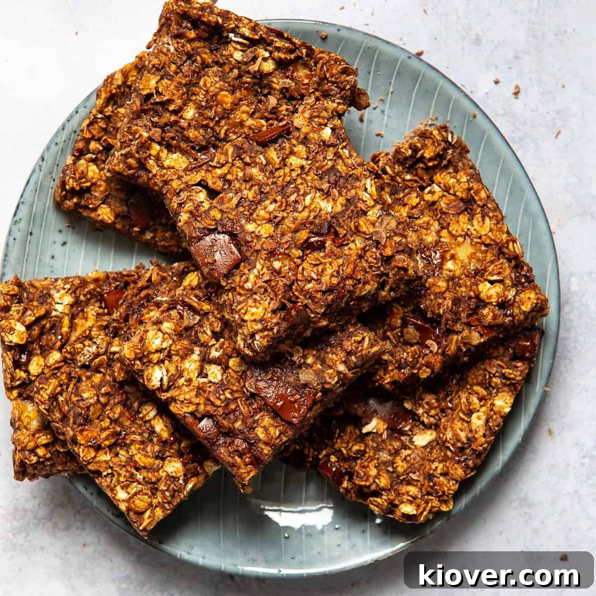 chocolate flapjacks sliced into squares served on a blue plate.