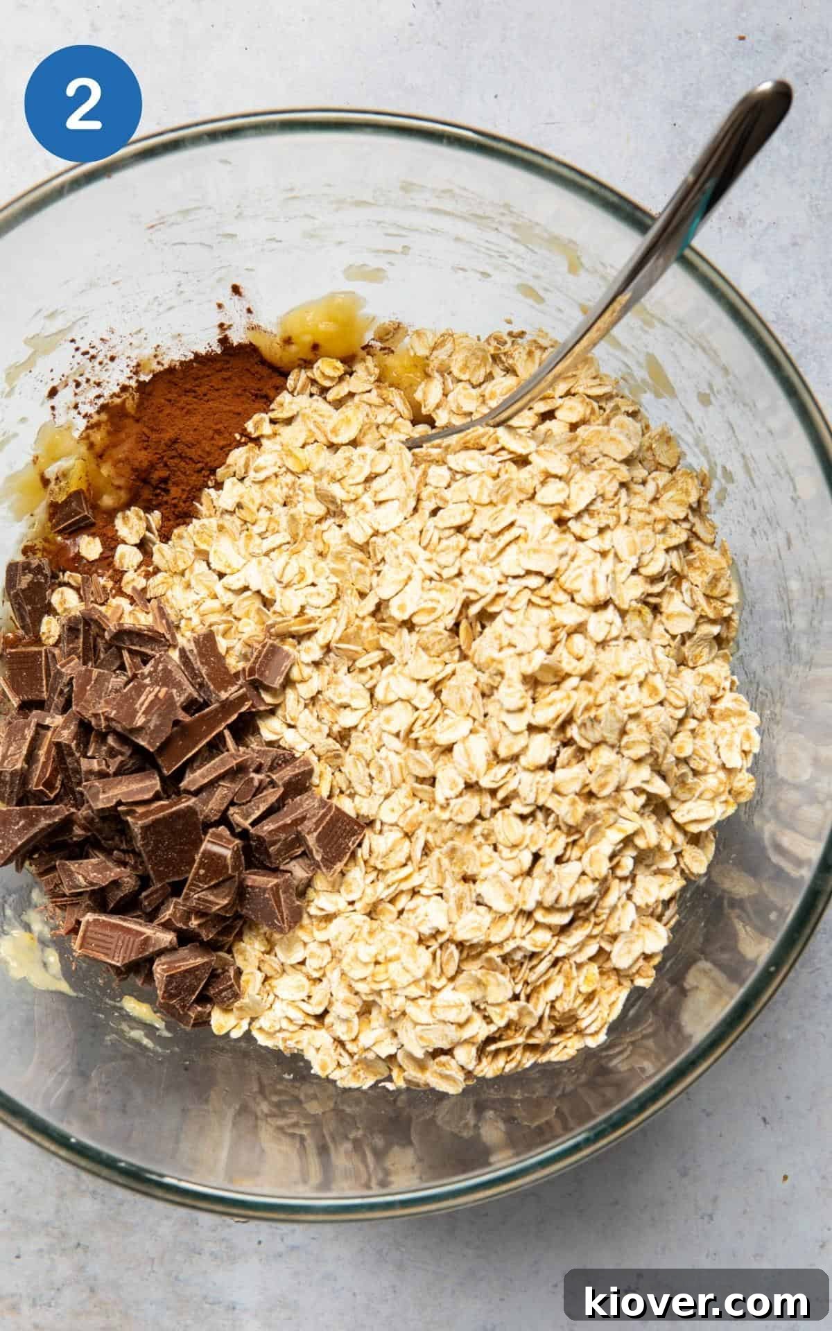 oats, chocolate, cacao powder and maple syrup being added to the mashed banana mixture.