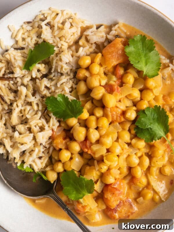 Chickpea curry with rice in a shallow white bowl.
