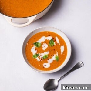 Roasted Tomato Soup with vegan cream and fresh basil on top.