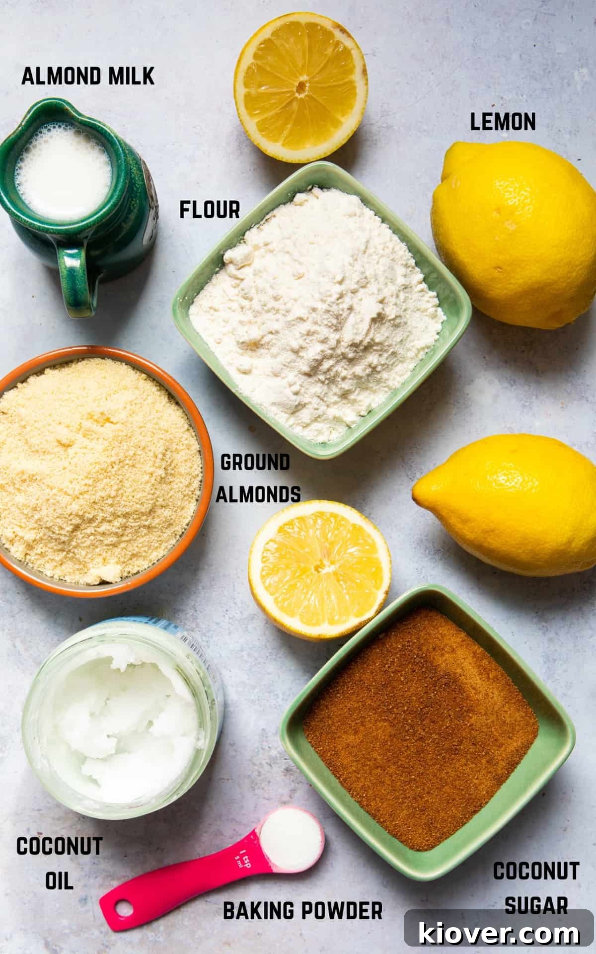 Vegan Lemon Drizzle Cake Recipe — Light Citrus Loaf 3 Ingredients to make lemon drizzle cake laid out on concrete surface.