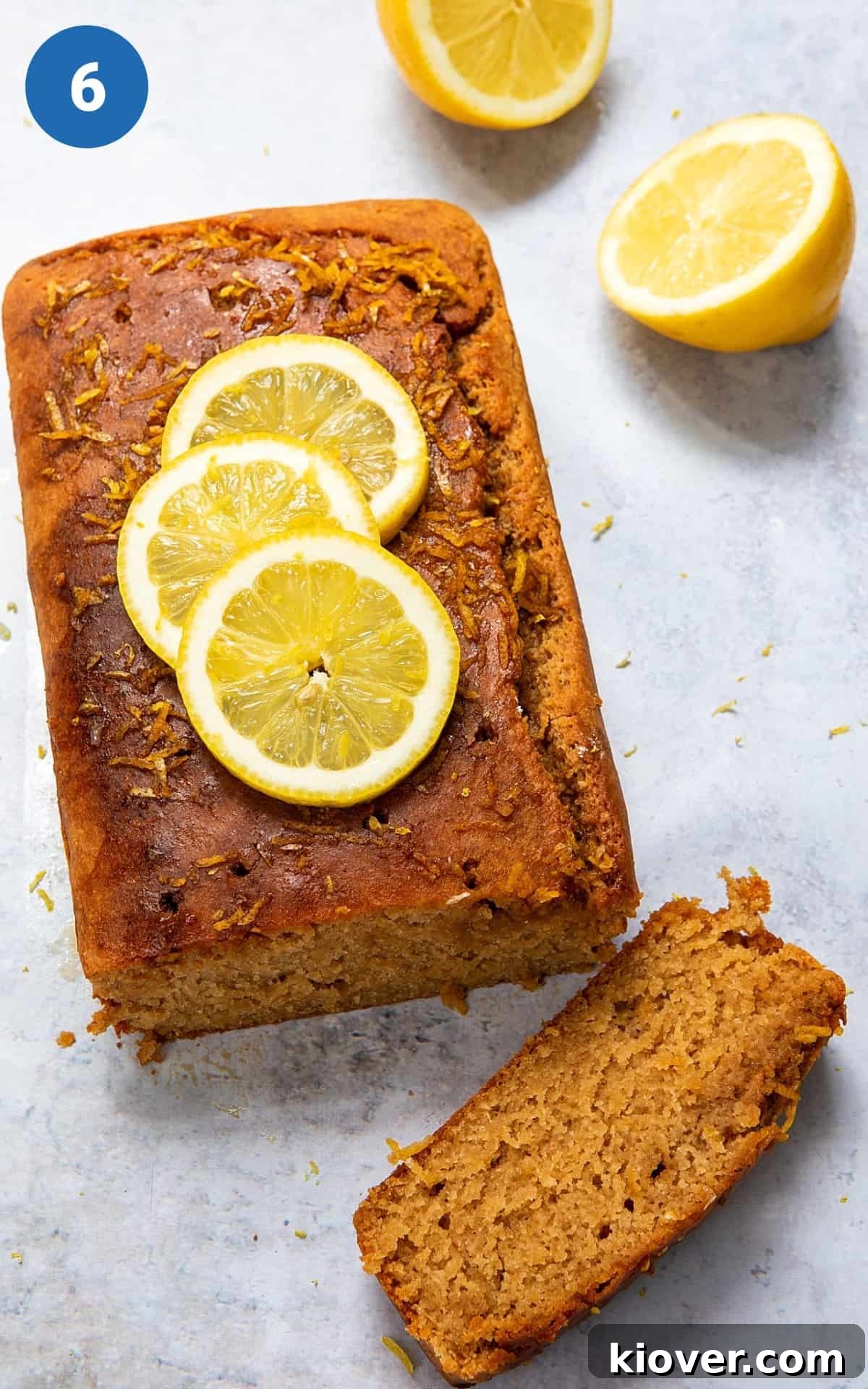 Vegan Lemon Drizzle Cake Recipe — Light Citrus Loaf 9 Lemon Drizzle cake cut into slices topped with fresh lemon slices.