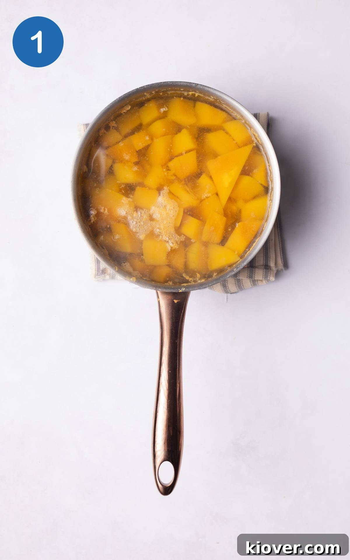 Pumpkin boiling in water in a pot.