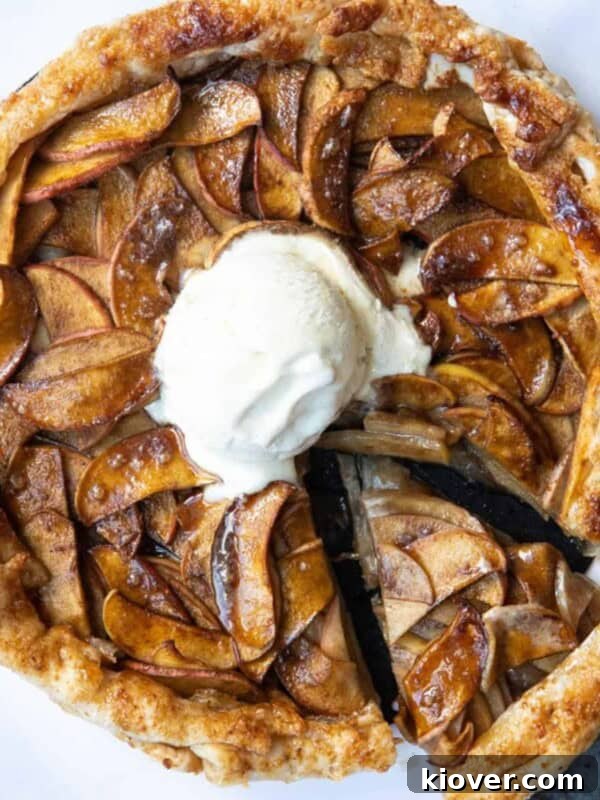 Puff Pastry Apple Tart on a white marble background with a scoop of ice cream in the centre