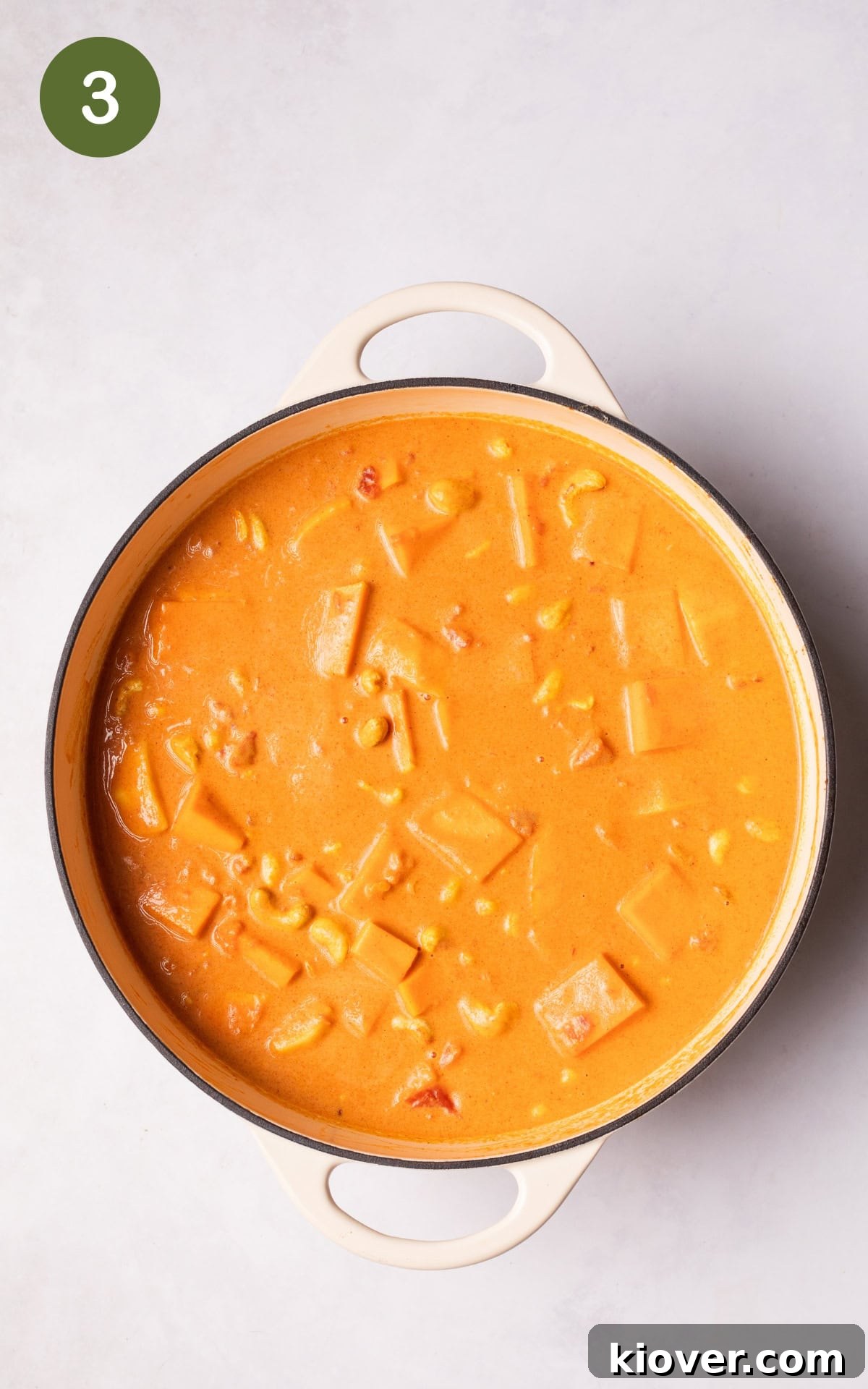 adding coconut milk and butternut squash to the pot.