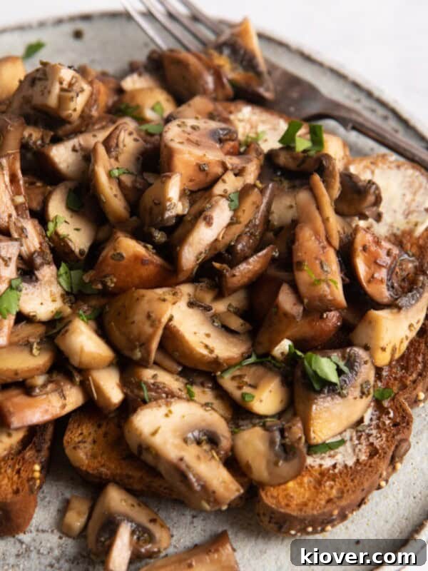 garlic mushrooms on toast with a white plate