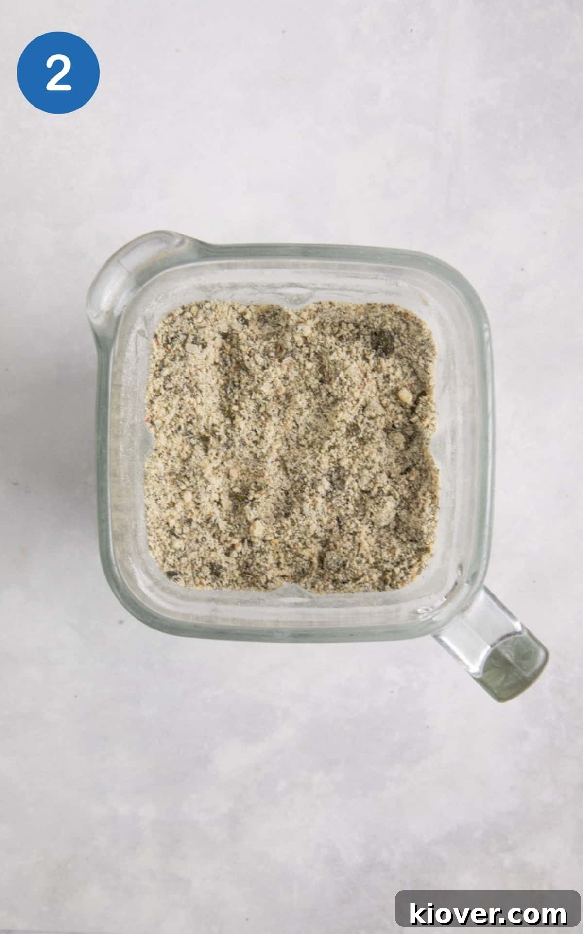 blended seeds with flour in food processor on white surface.